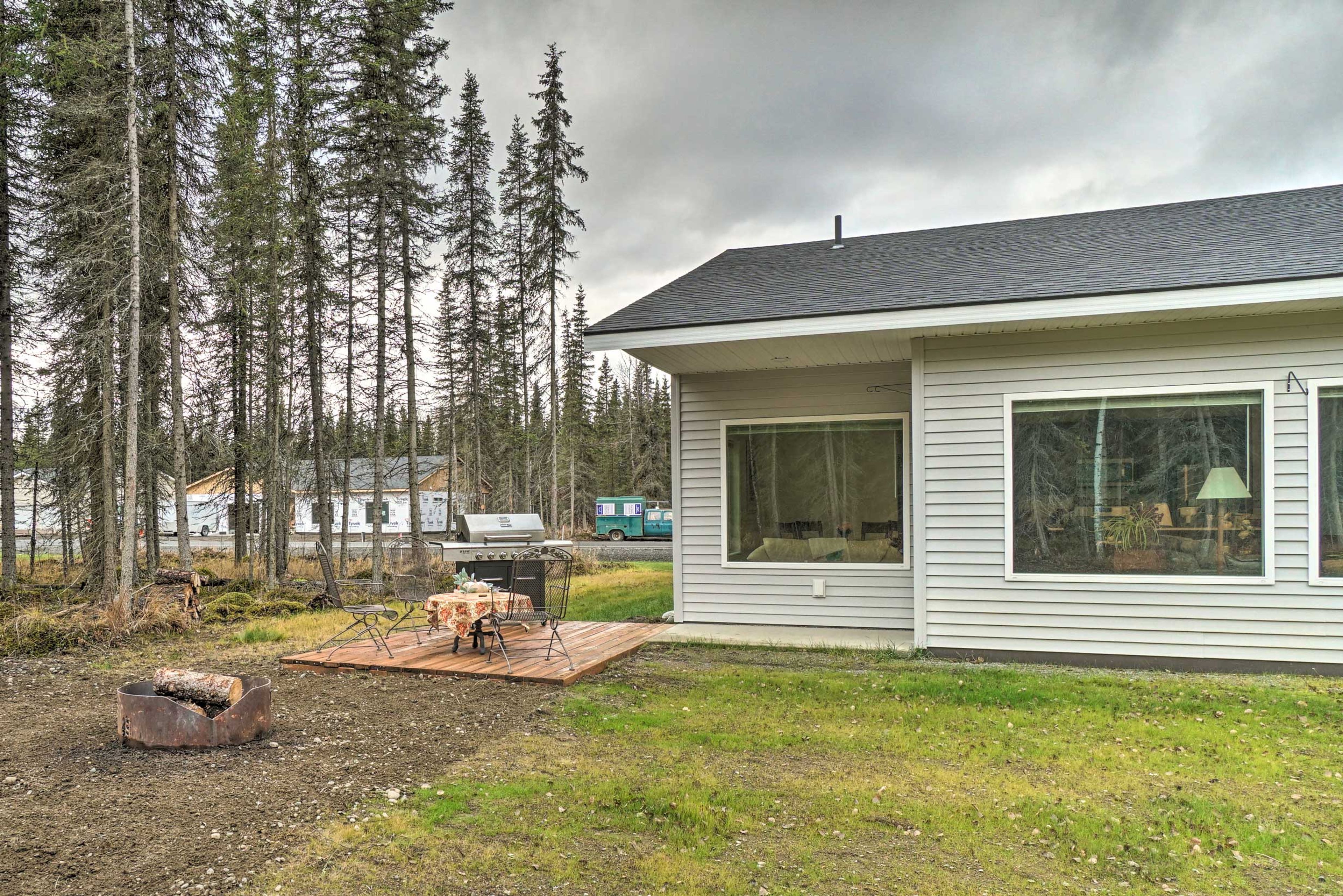 The yard includes a furnished patio and fire pit.