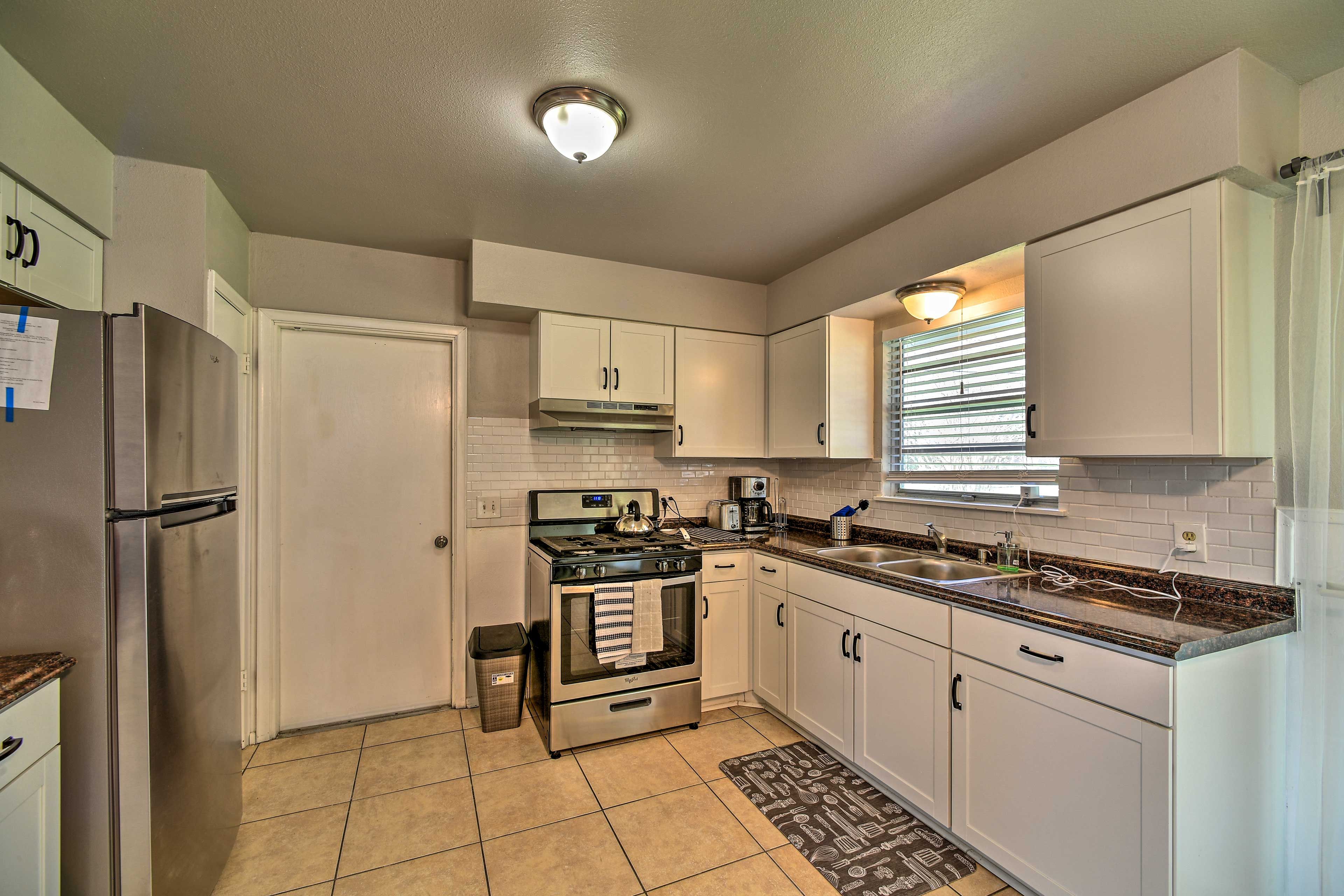 The kitchen hosts new stainless steel appliances.