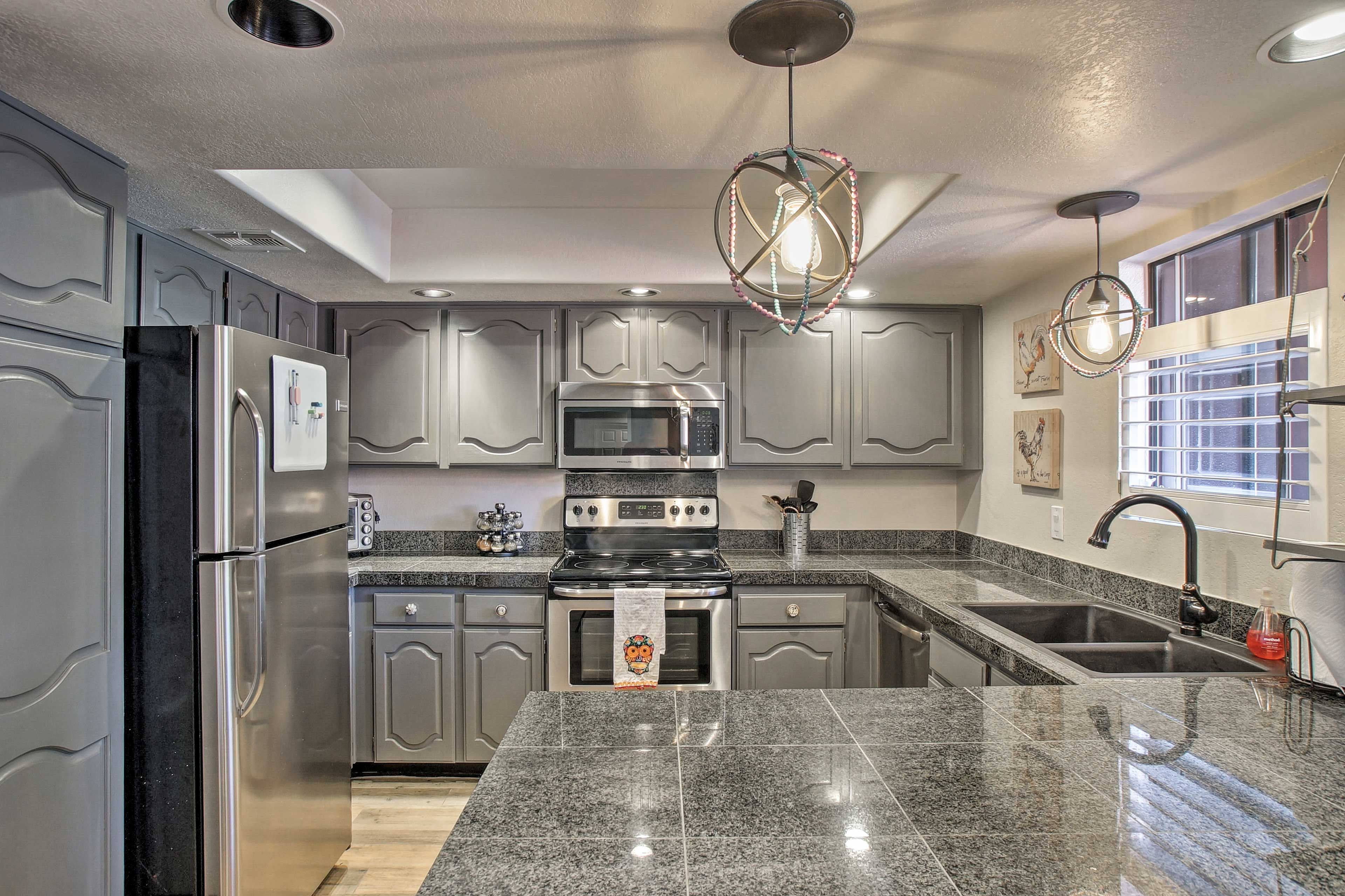 The kitchen is outfitted with stainless steel appliances and granite countertops