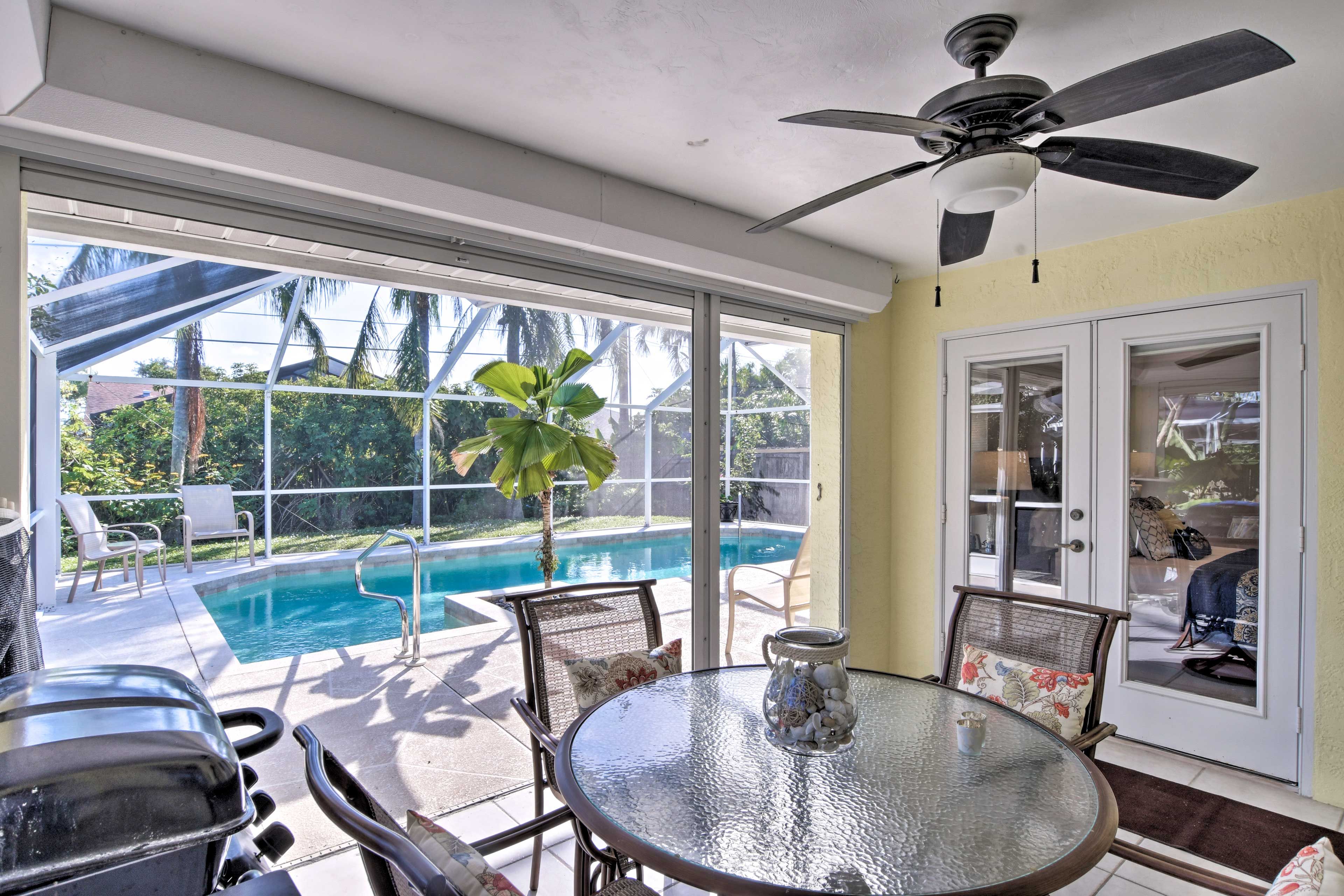 The dining area features a patio table and gas grill.