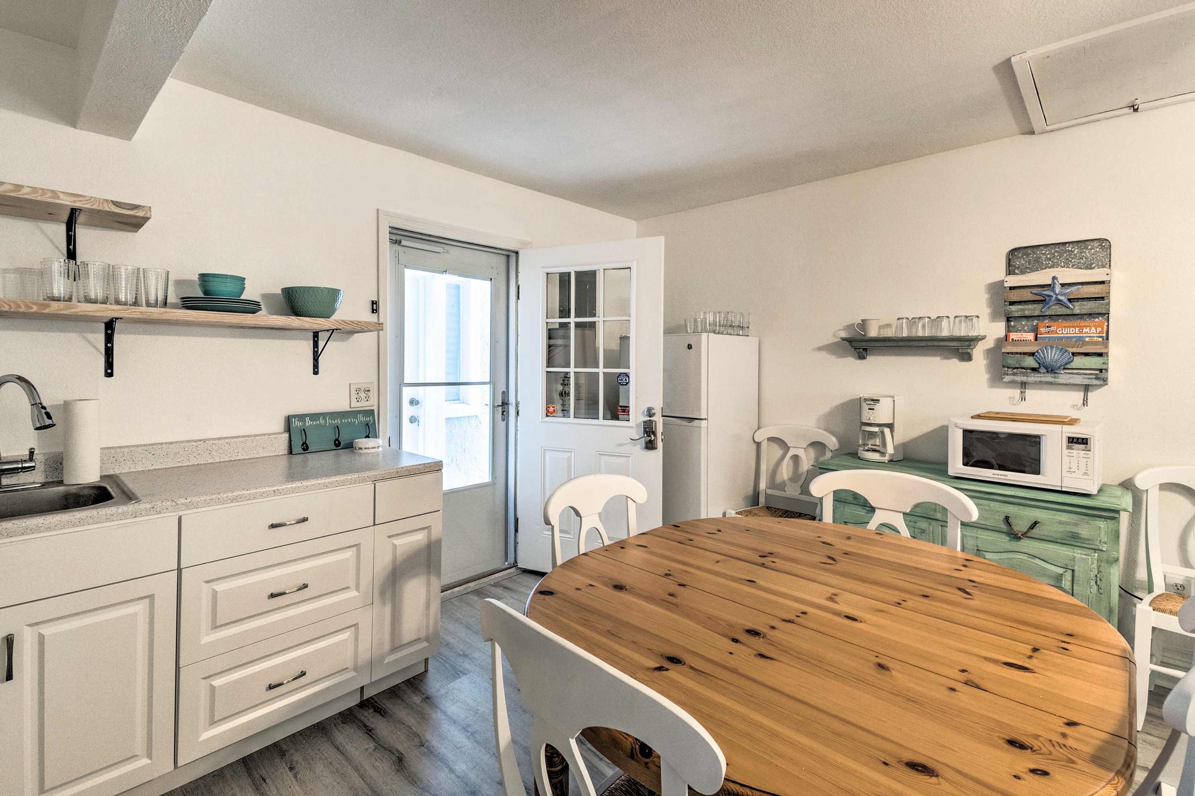 The home features a well-equipped kitchen, complete with dishware & flatware.