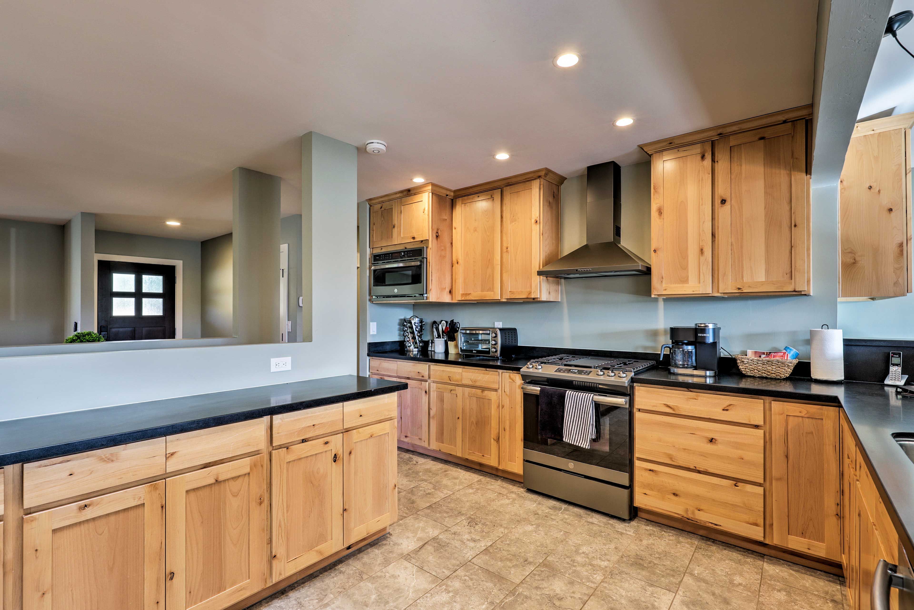 The renovated kitchen features stainless steel appliances and granite counters.
