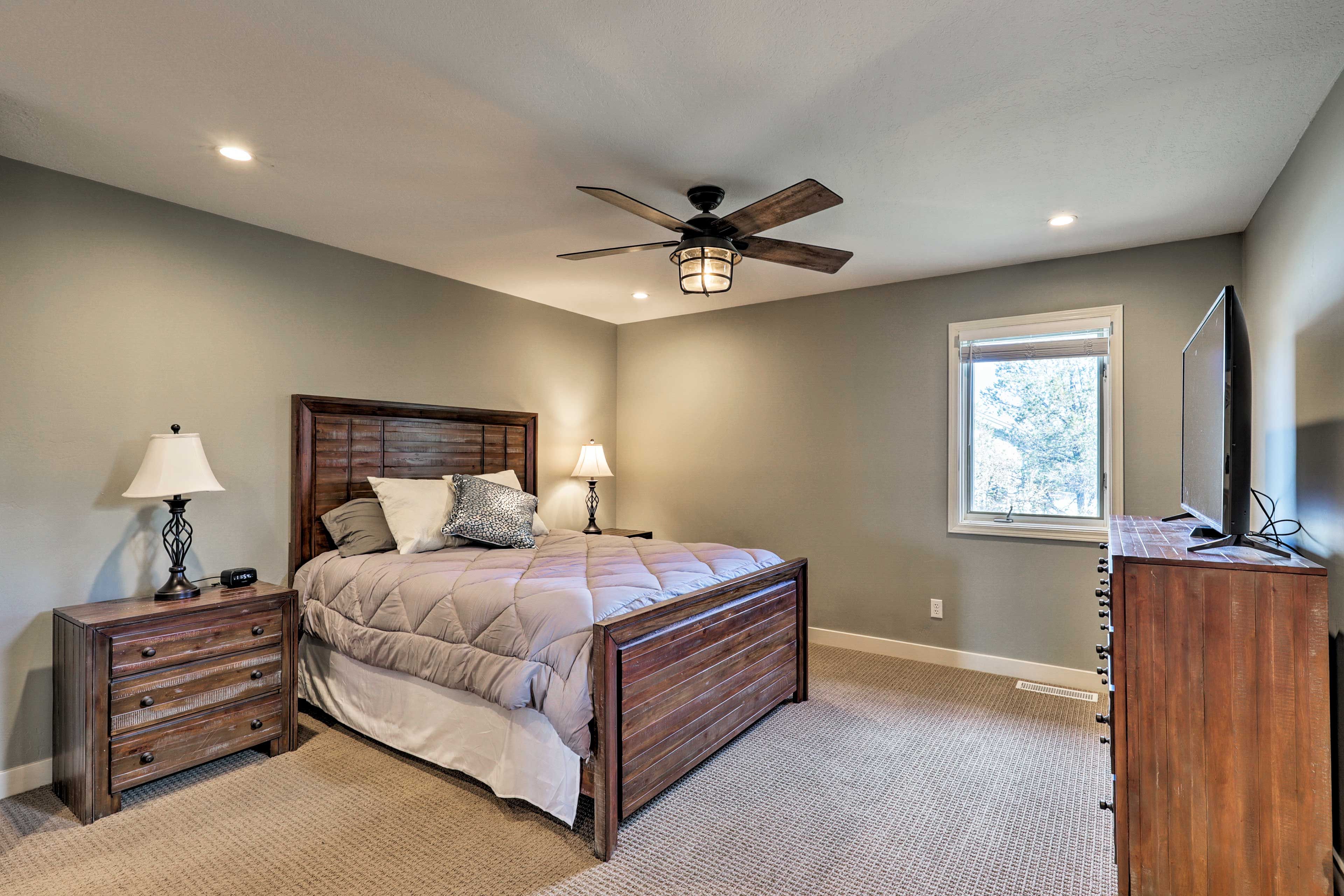 Enjoy the comfort of the queen-sized bed in the bedroom suite.