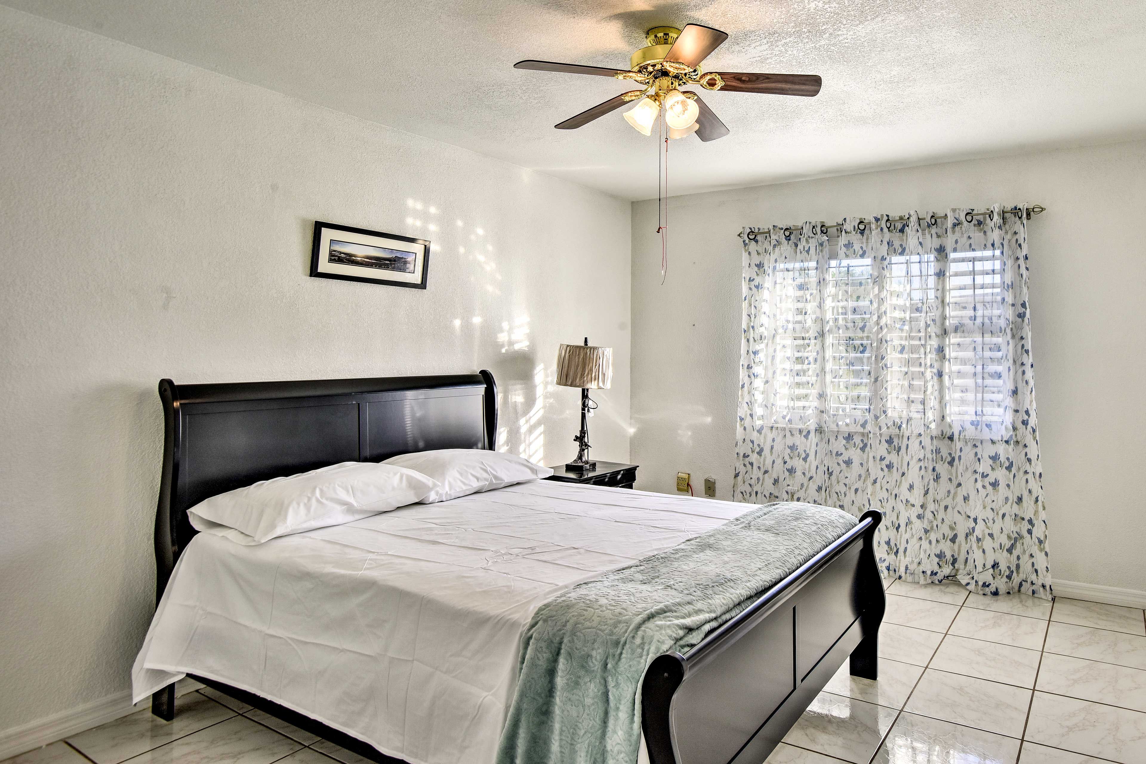 Retire to the airy primary bedroom at the end of each day.