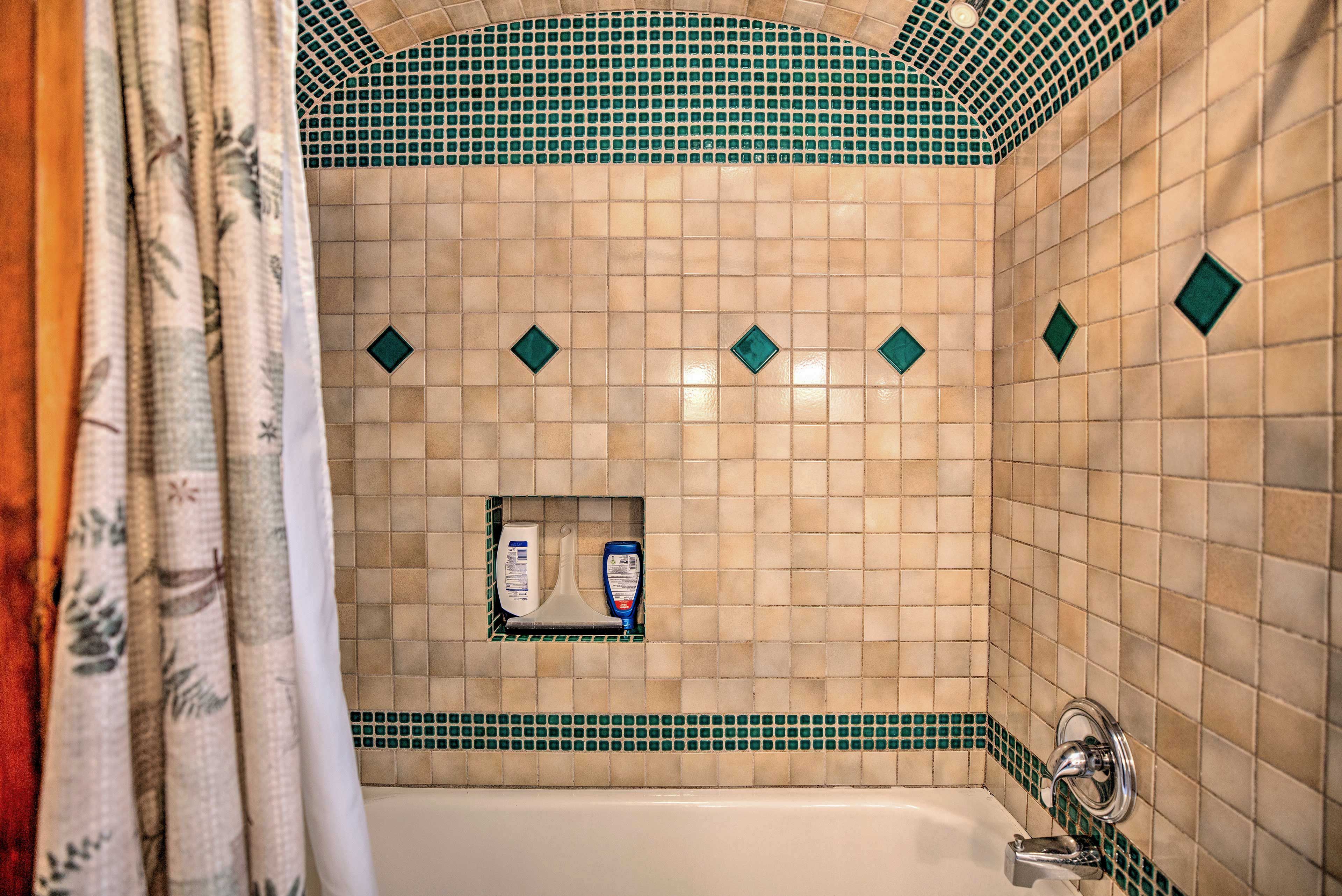 There is a unique tub/shower in the bathroom.