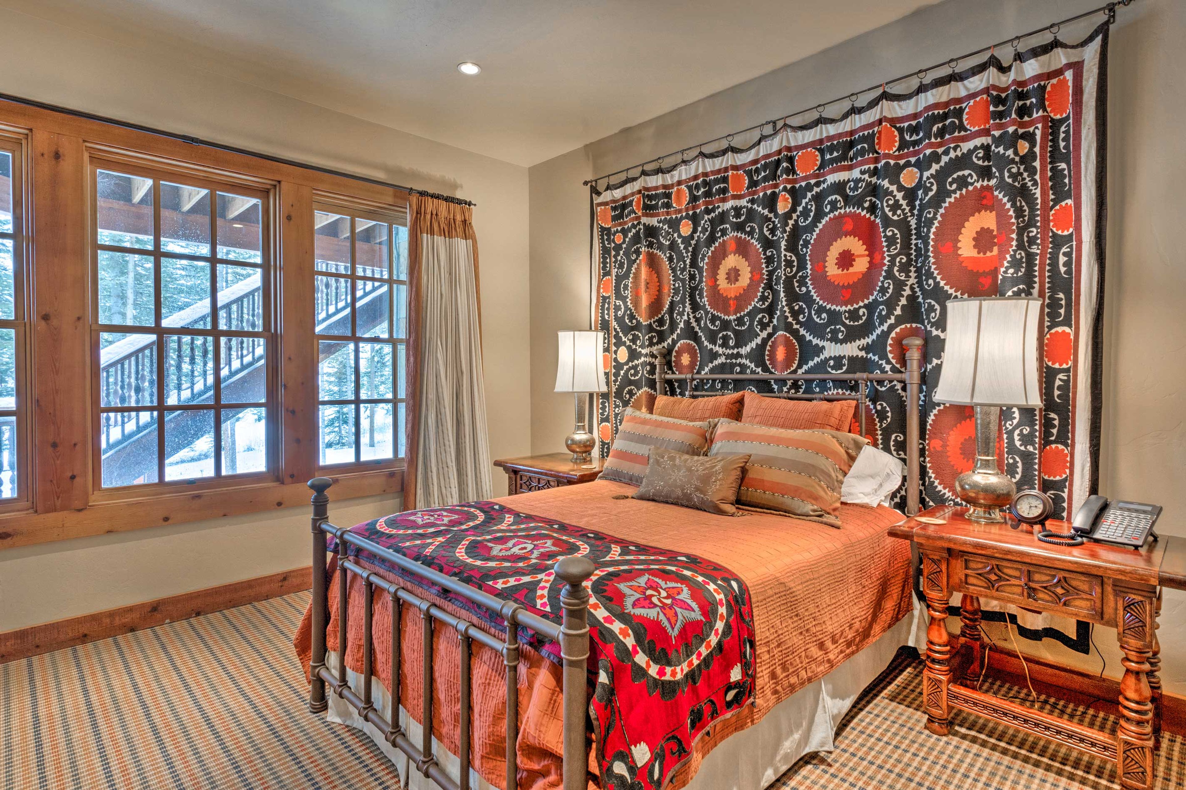The tastefully decorated fourth bedroom is equipped with a queen-sized bed.