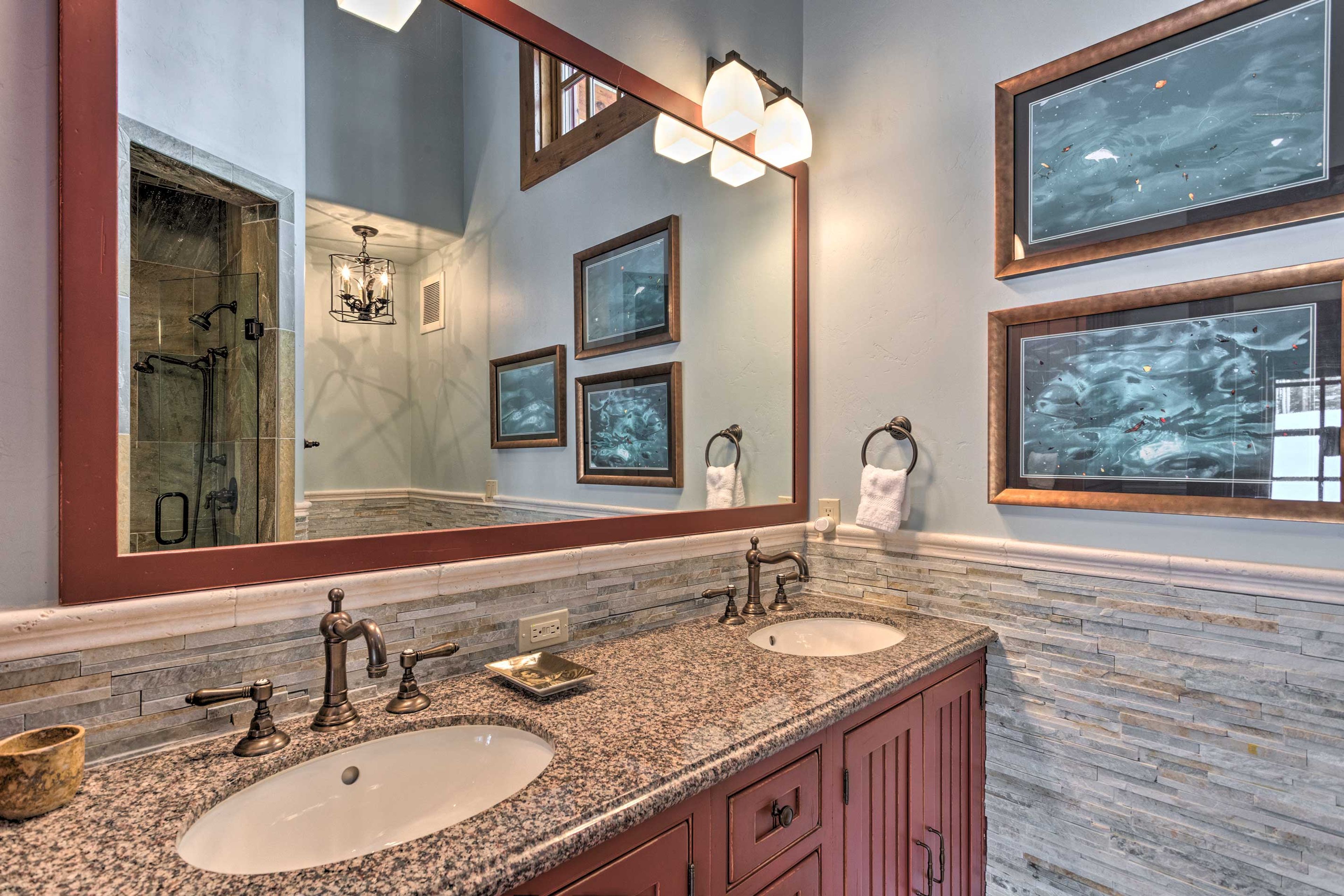 The seventh bath is complete with double sinks & beautiful stone walk-in shower.