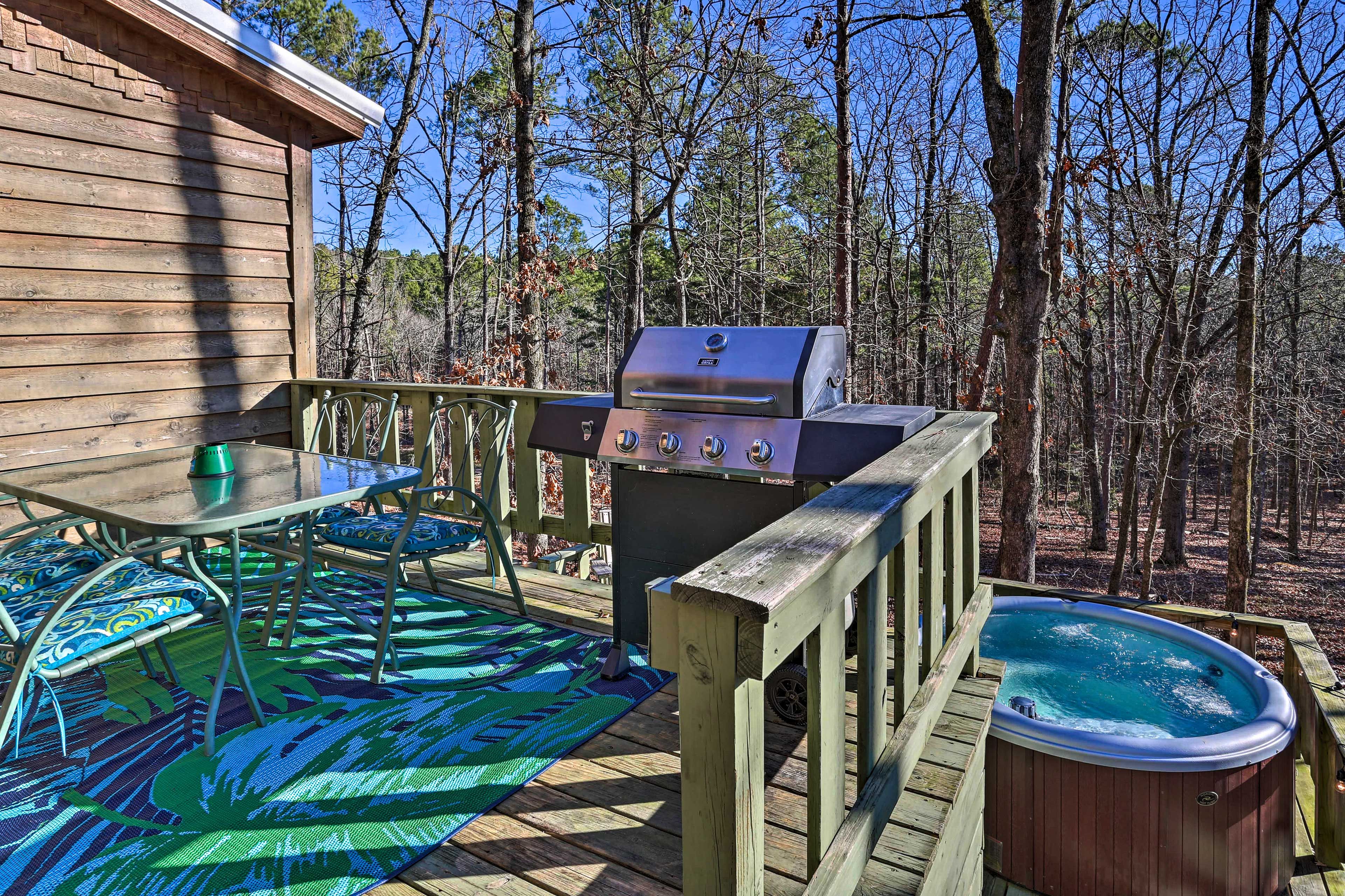 This cozy cabin offers desirable amenities like a hot tub & grill.