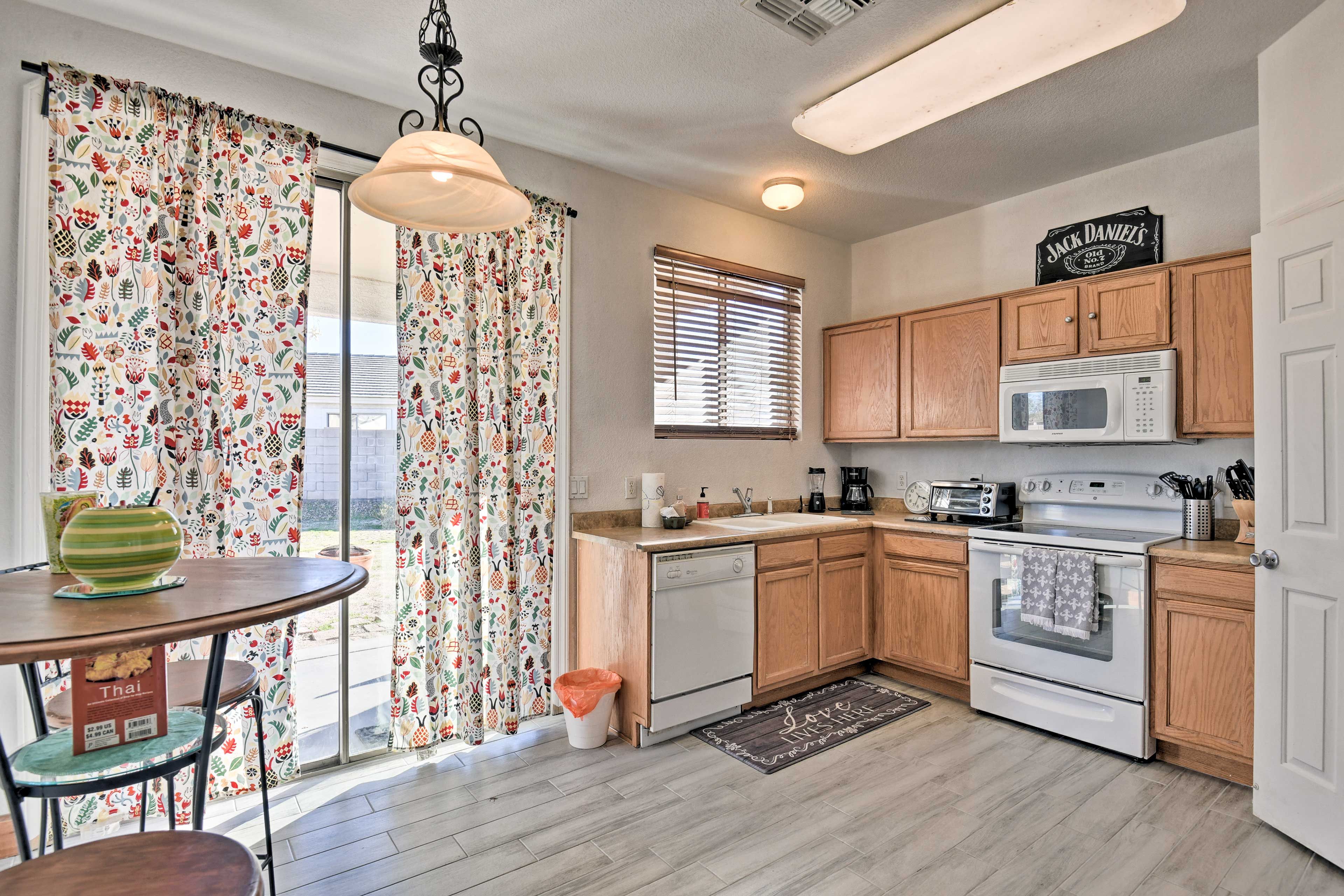The eat-in kitchen features updated appliances and a high-top dining table.