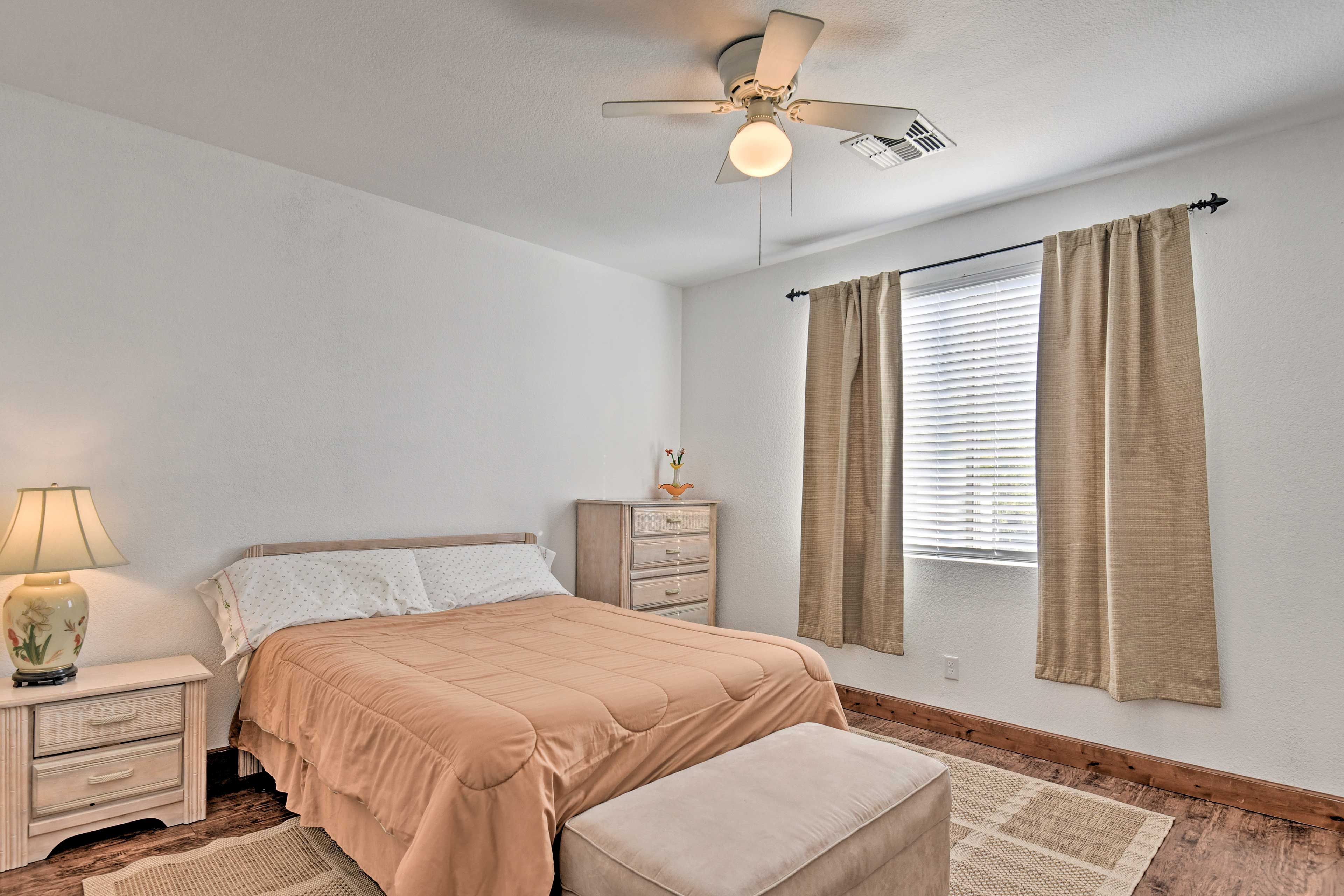 Enjoy the comfort of the queen-sized bed in this bedroom.