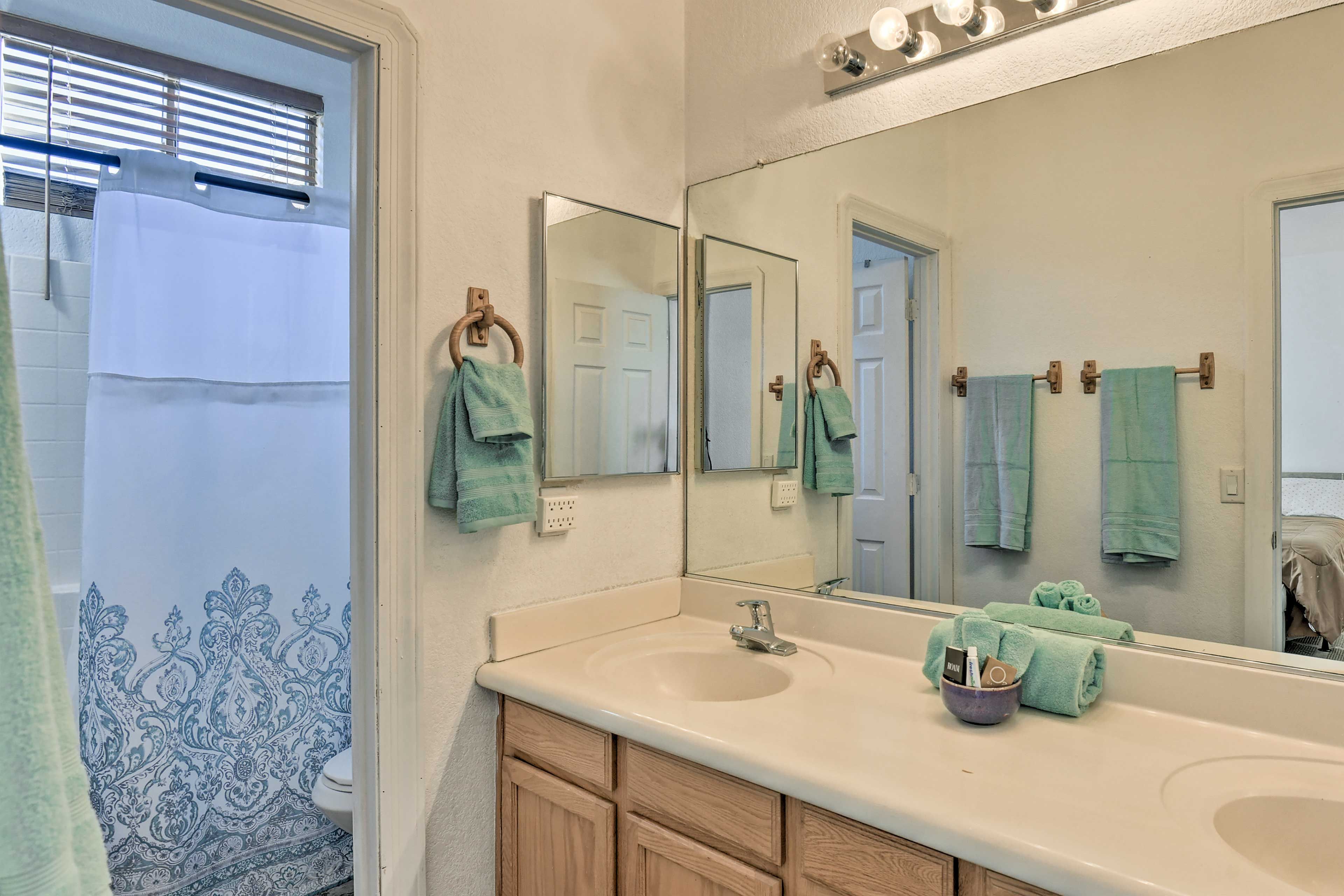 The en-suite bath features double sinks and a shower/tub combo.
