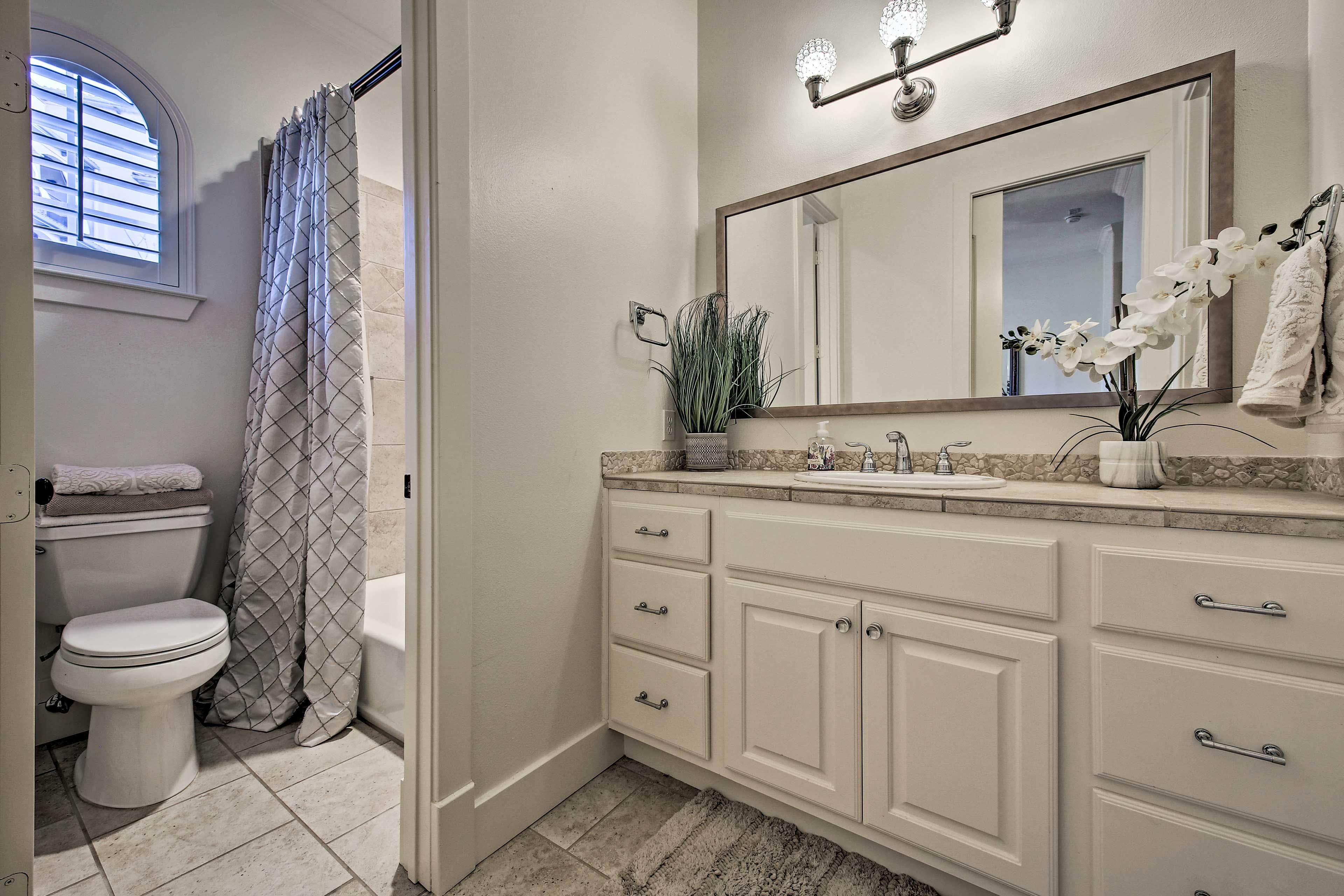 Rinse the day off in this bathroom that is one of three and a half on property.