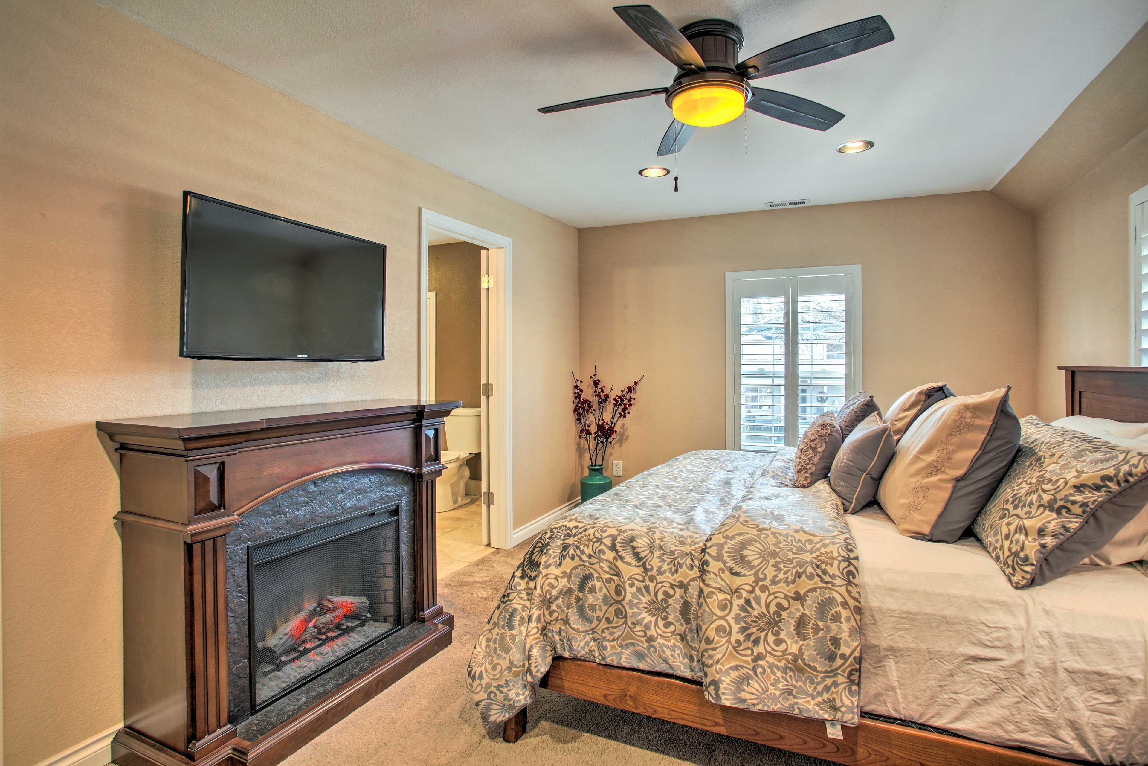The master bedroom boasts a mounted flat-screen TV.