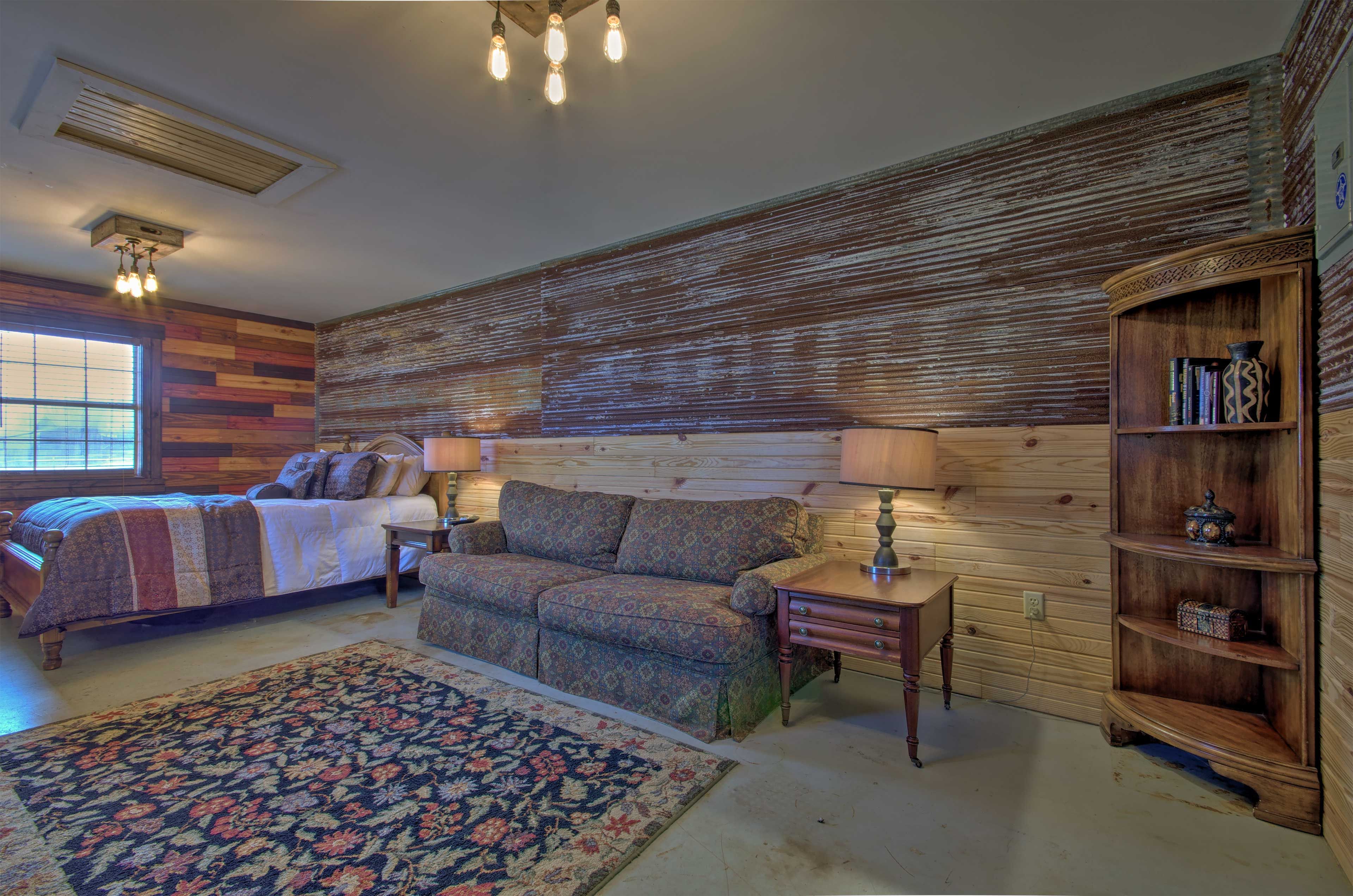 The interior offers a queen bed, couch, and TV.