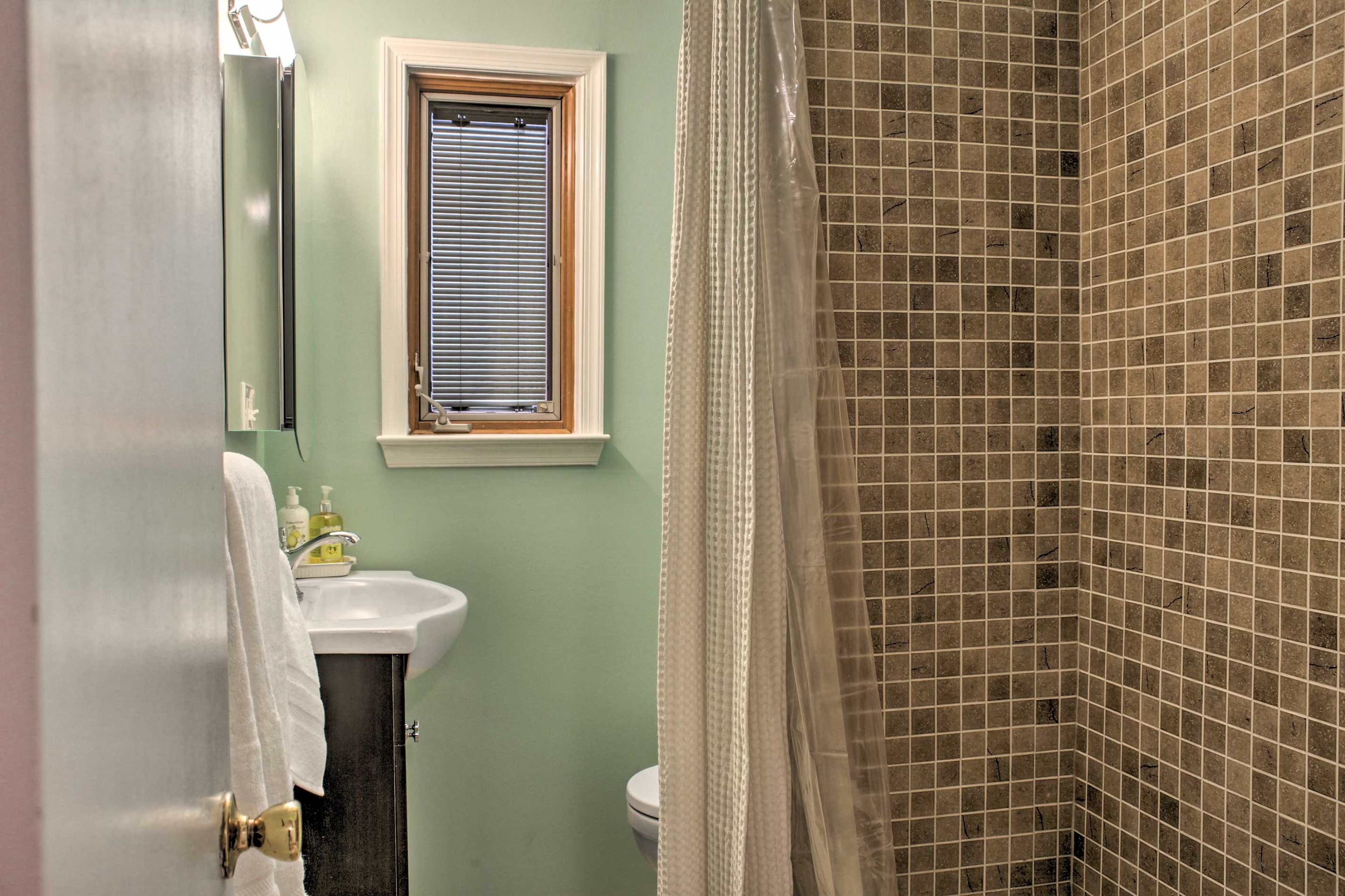 This second bathroom features a tile bathroom.