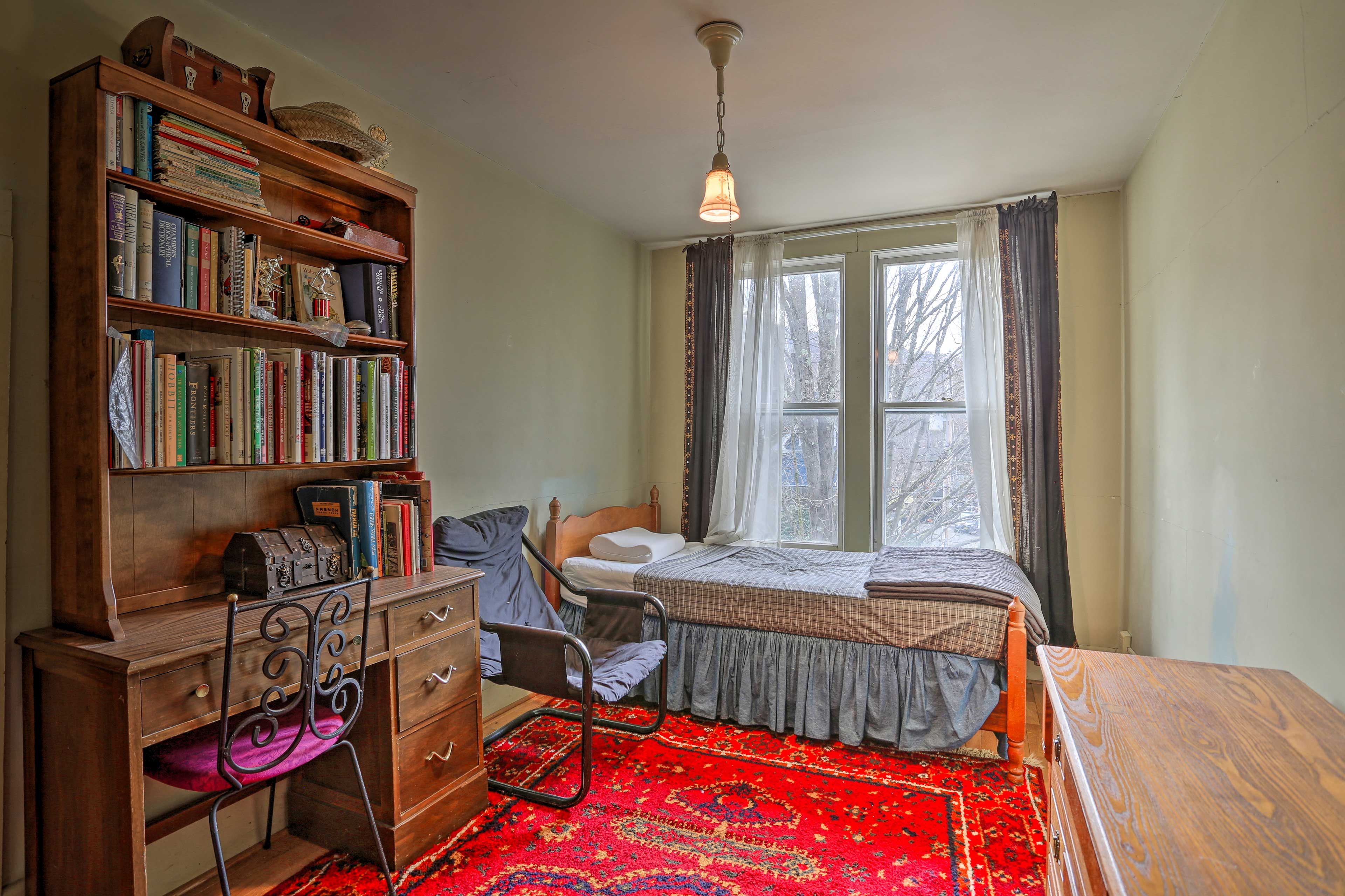 The fifth bedroom has a view of the neighborhood from the twin bed.