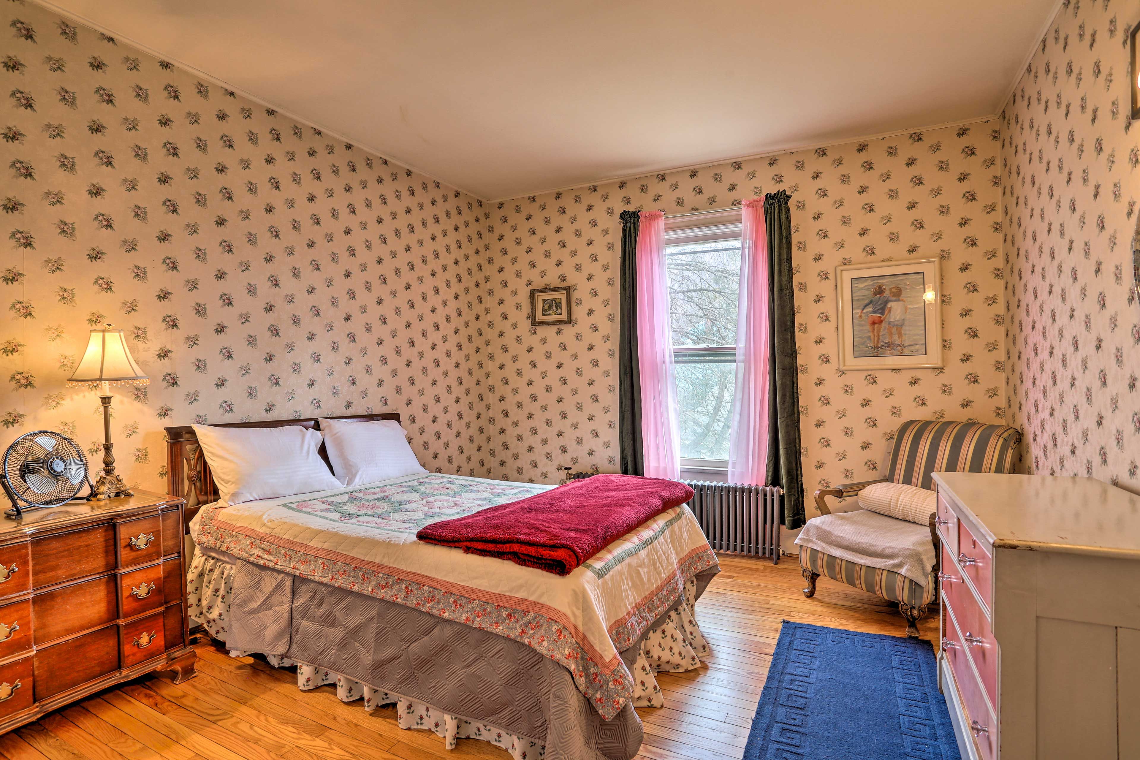 The third bedroom has vintage details like the dresser and authentic wallpaper!