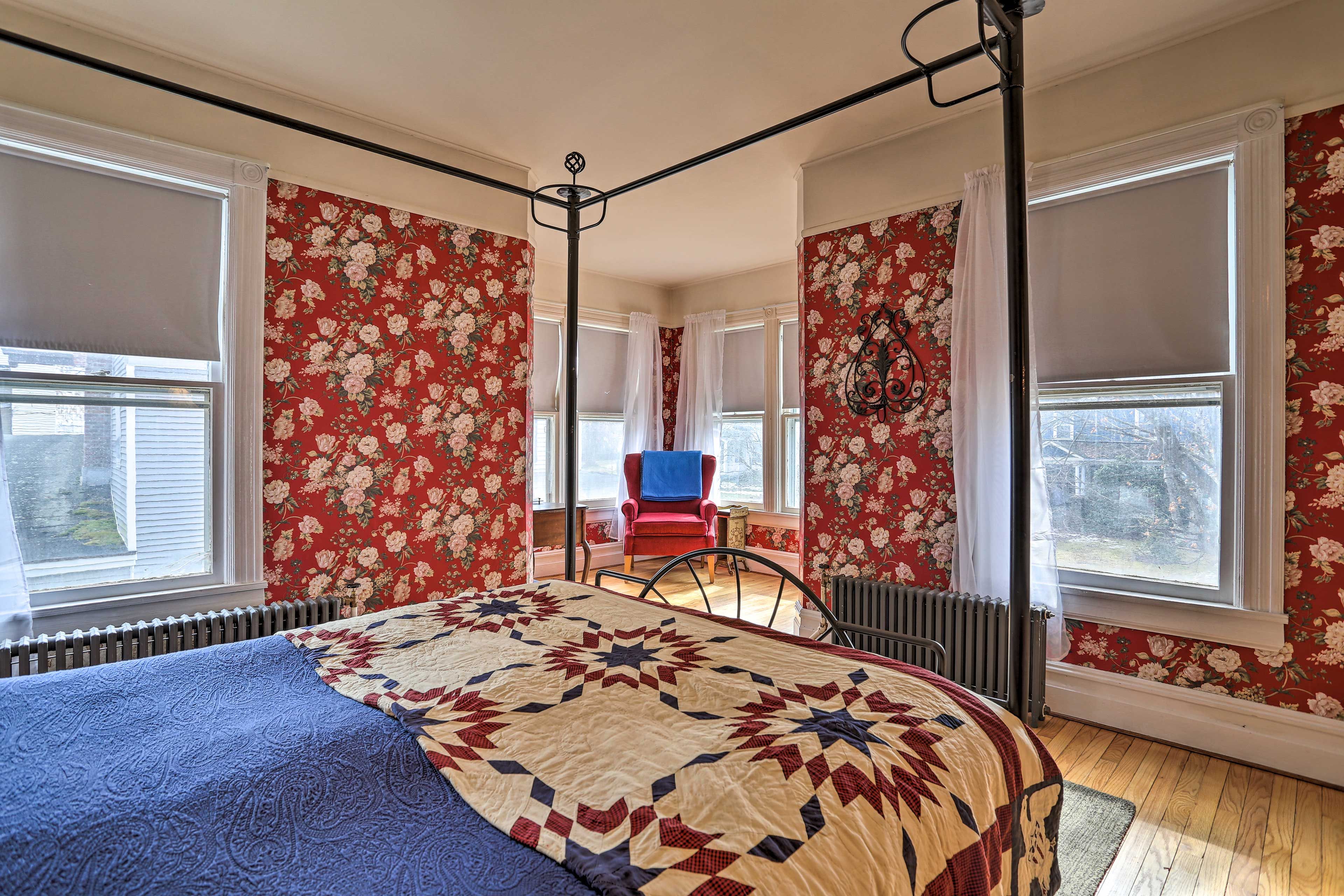 This patriotic room has a reading chair and vintage floral wallpaper!