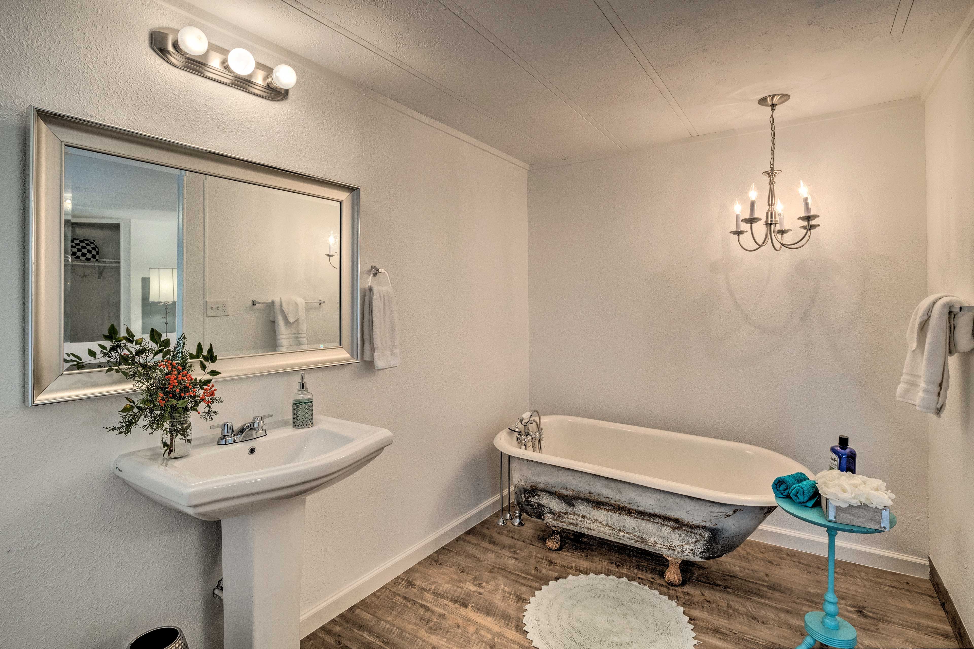 The en-suite bathroom features a vintage claw-foot bathtub.