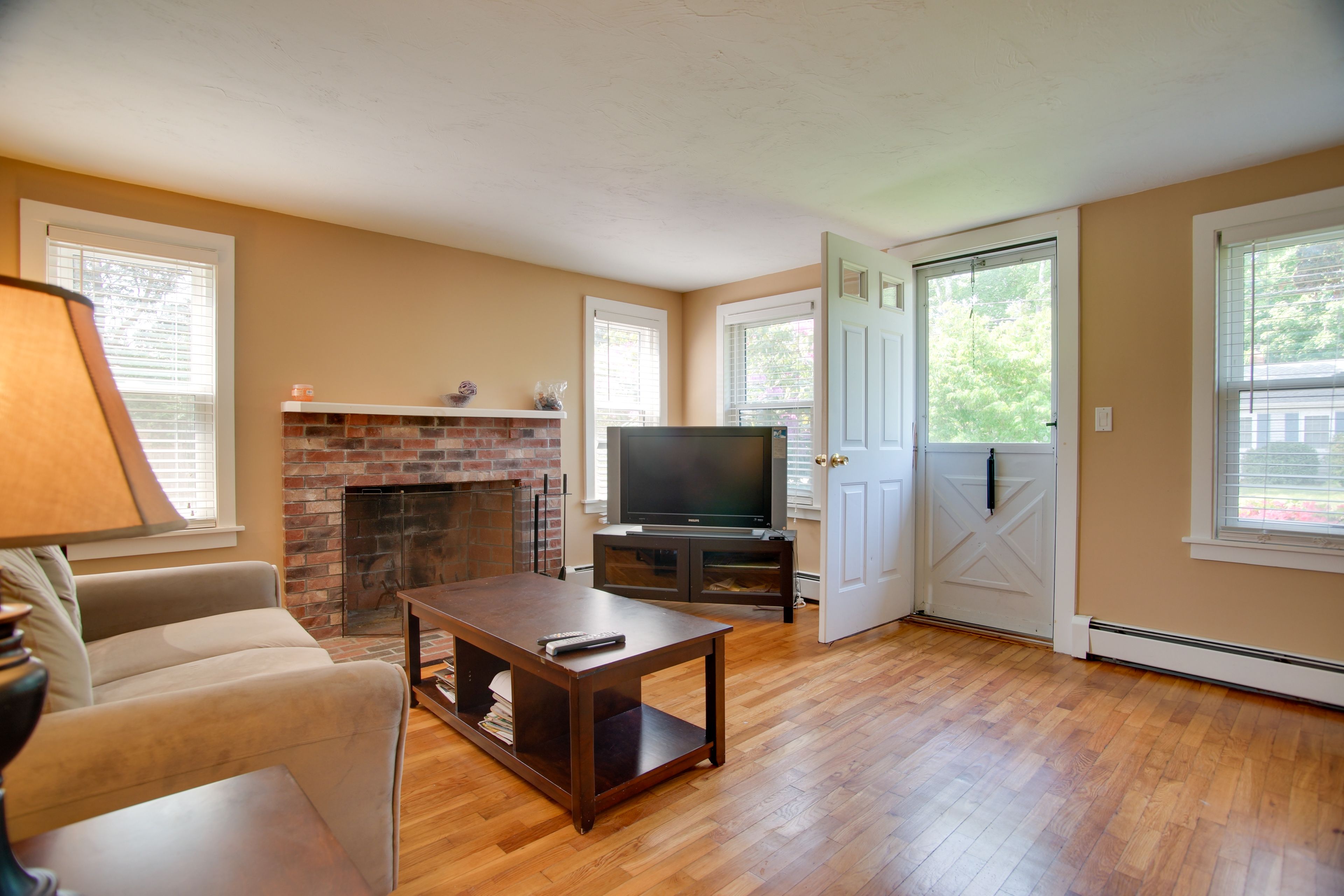 Downstairs Living Room | Wood-Burning Fireplace | Window A/C Units