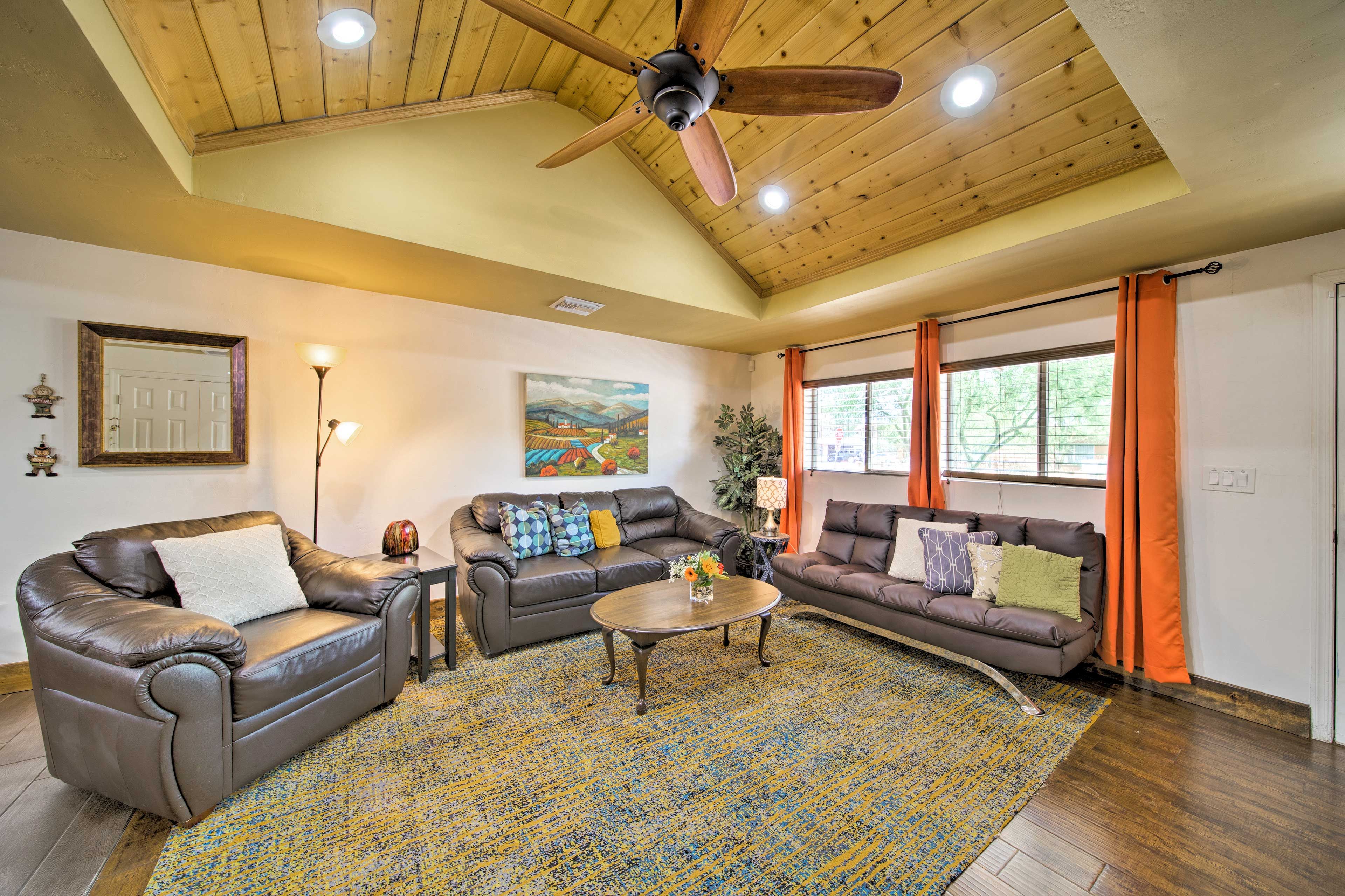 Vaulted ceilings, plush furnishings, and hardwood floors elevate this home.