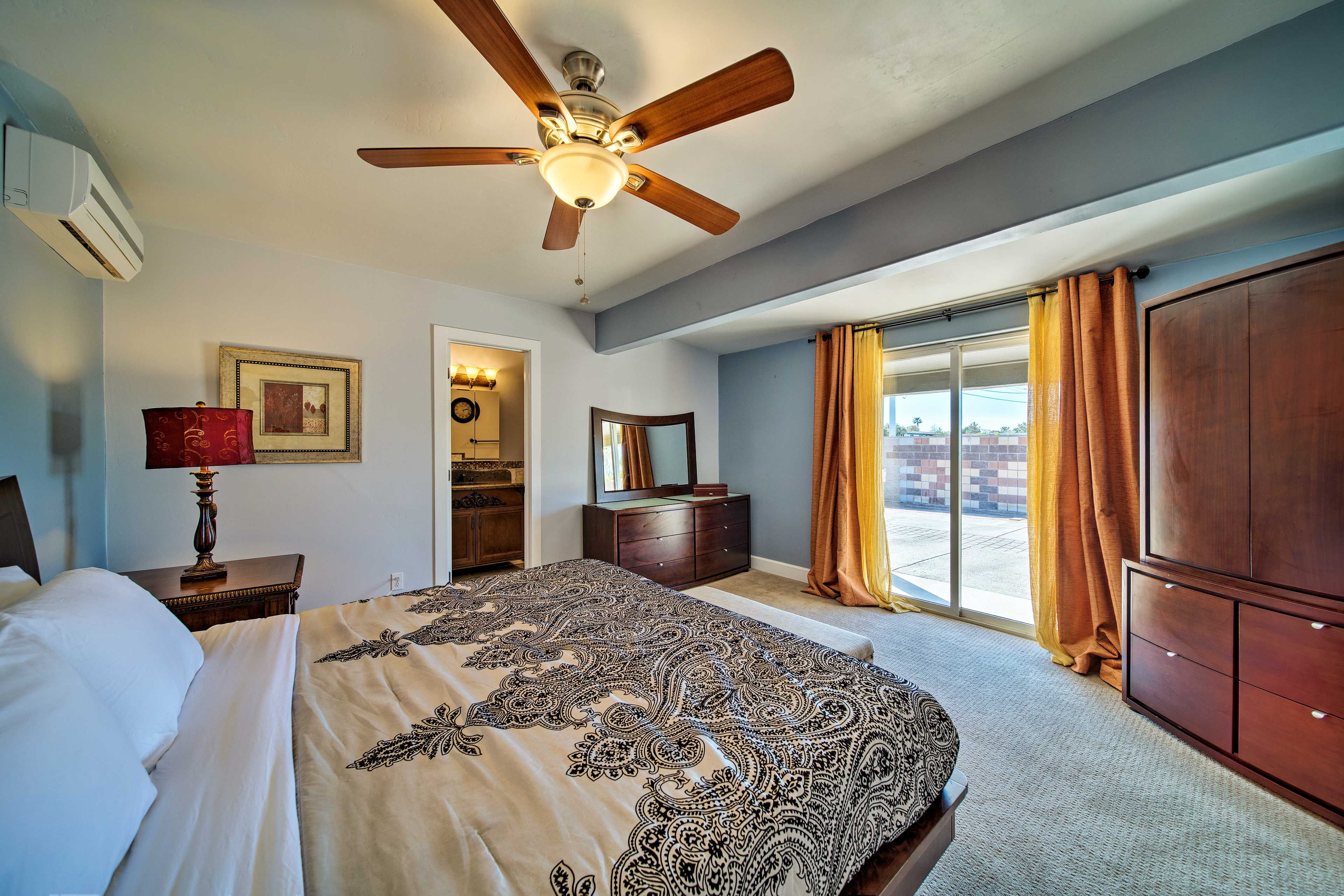 Let the breeze from the ceiling fan usher you to sleep in this spacious bedroom.