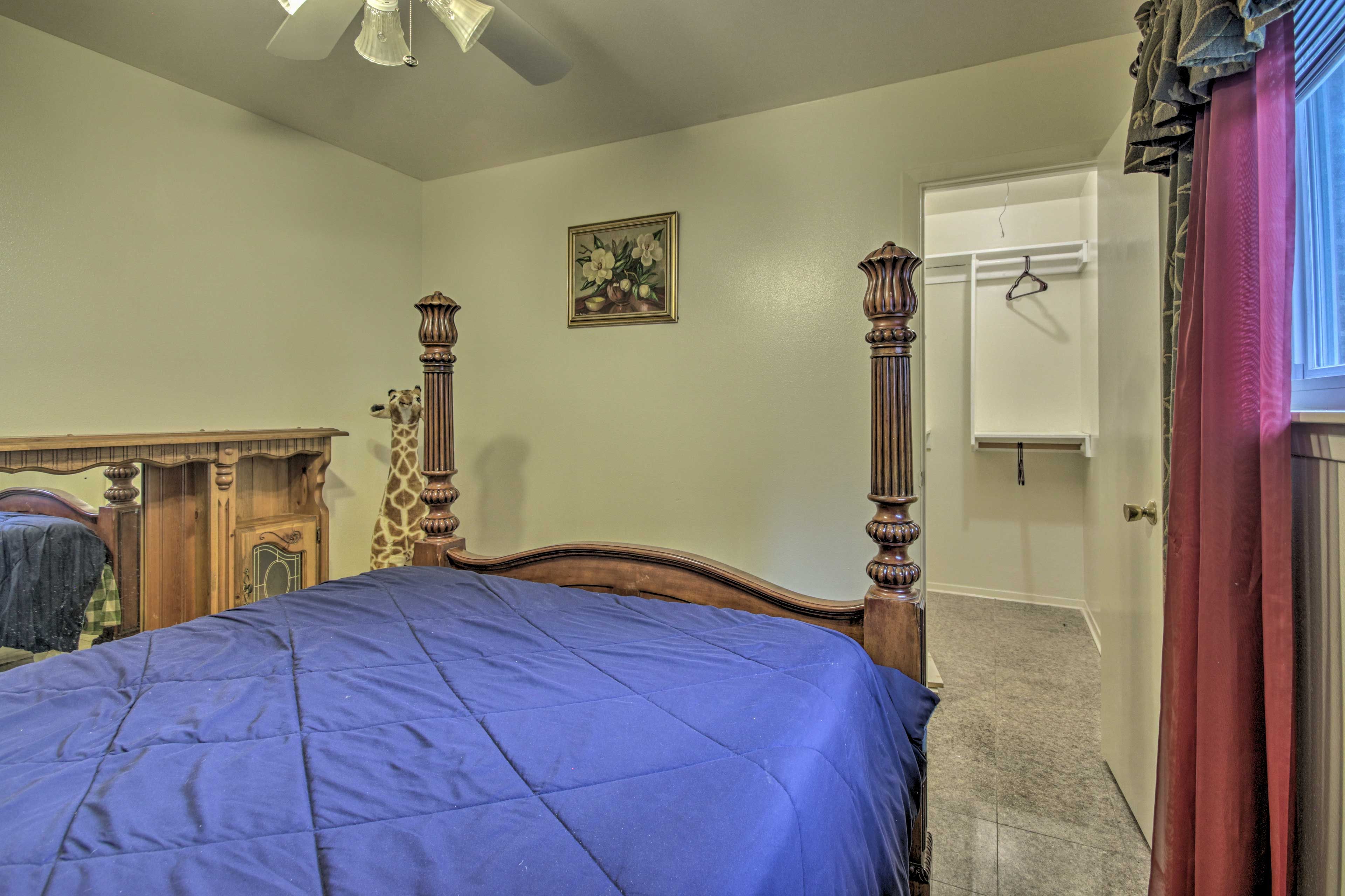 This room has a walk-in closet and queen-sized bed.