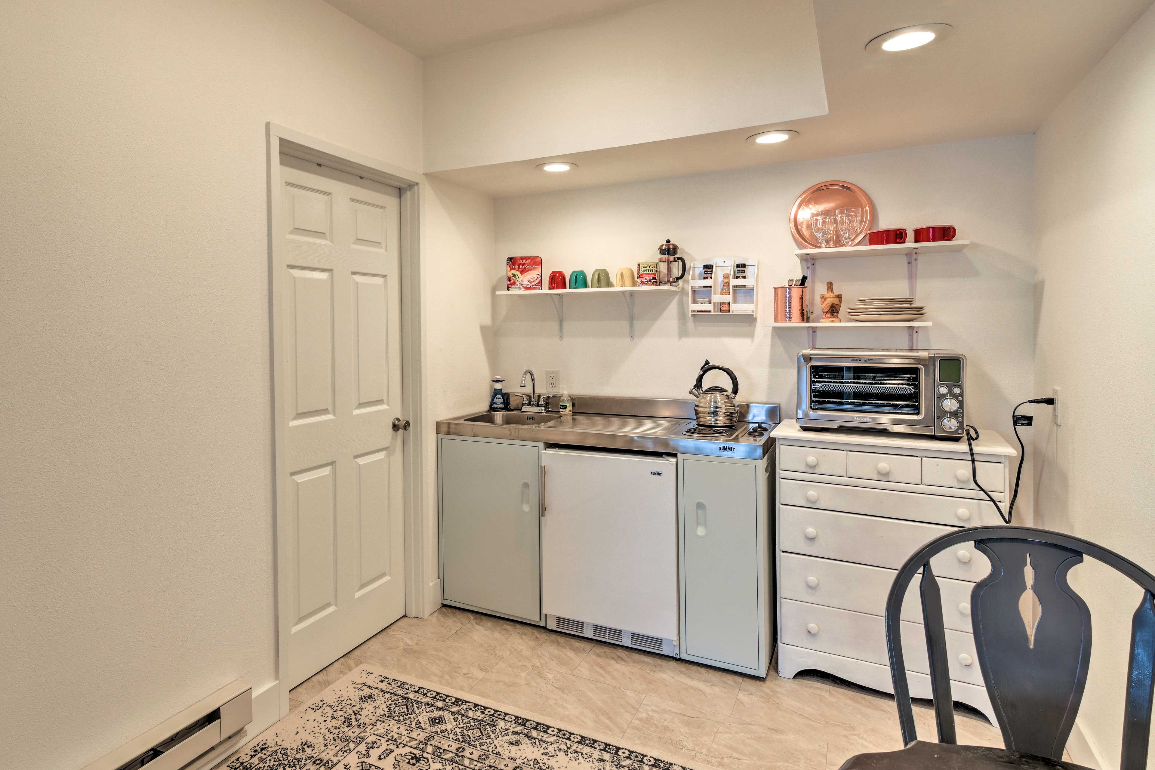 The kitchenette is well-stocked with all the essentials.