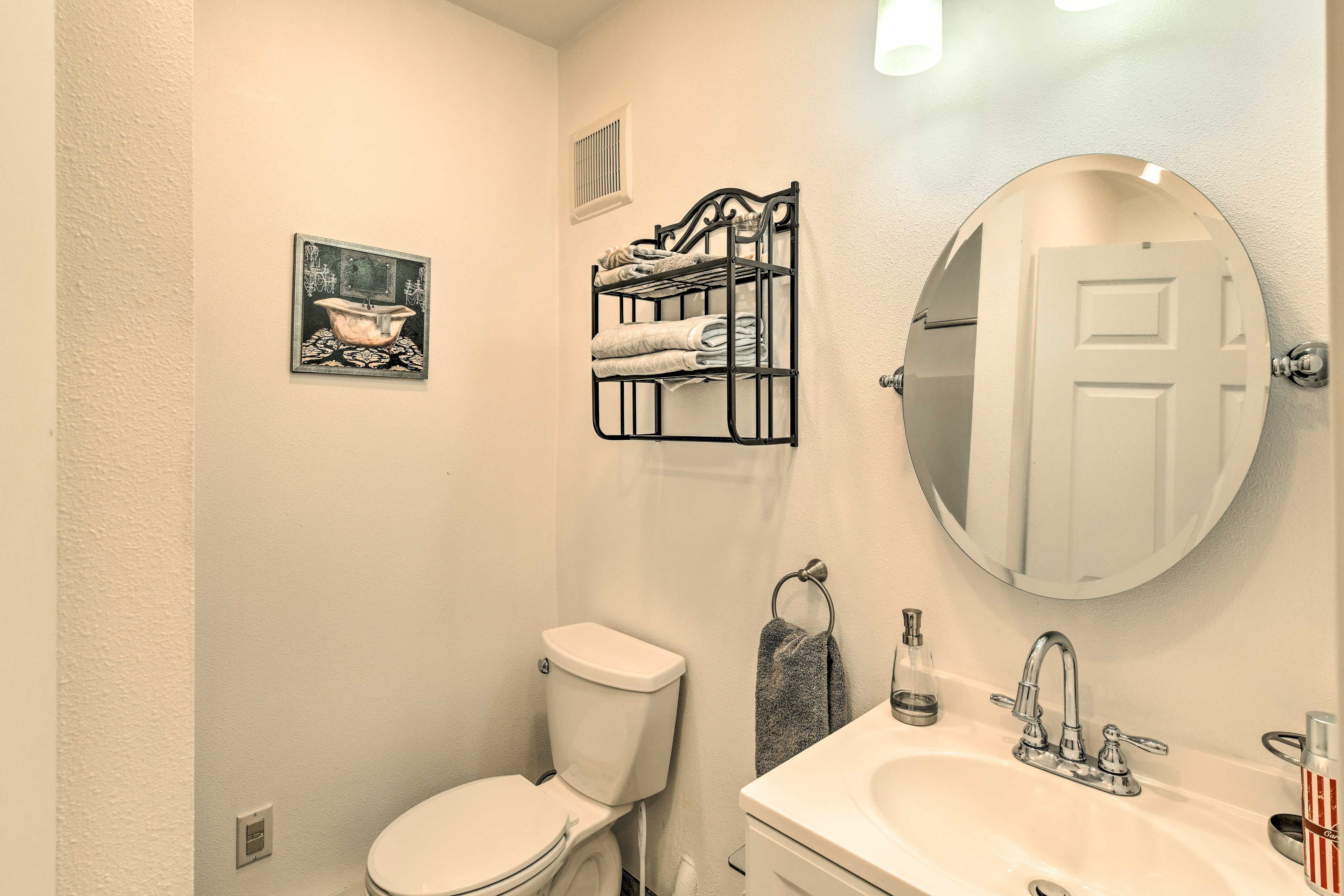 The full bathroom is stocked with toiletries & towels.