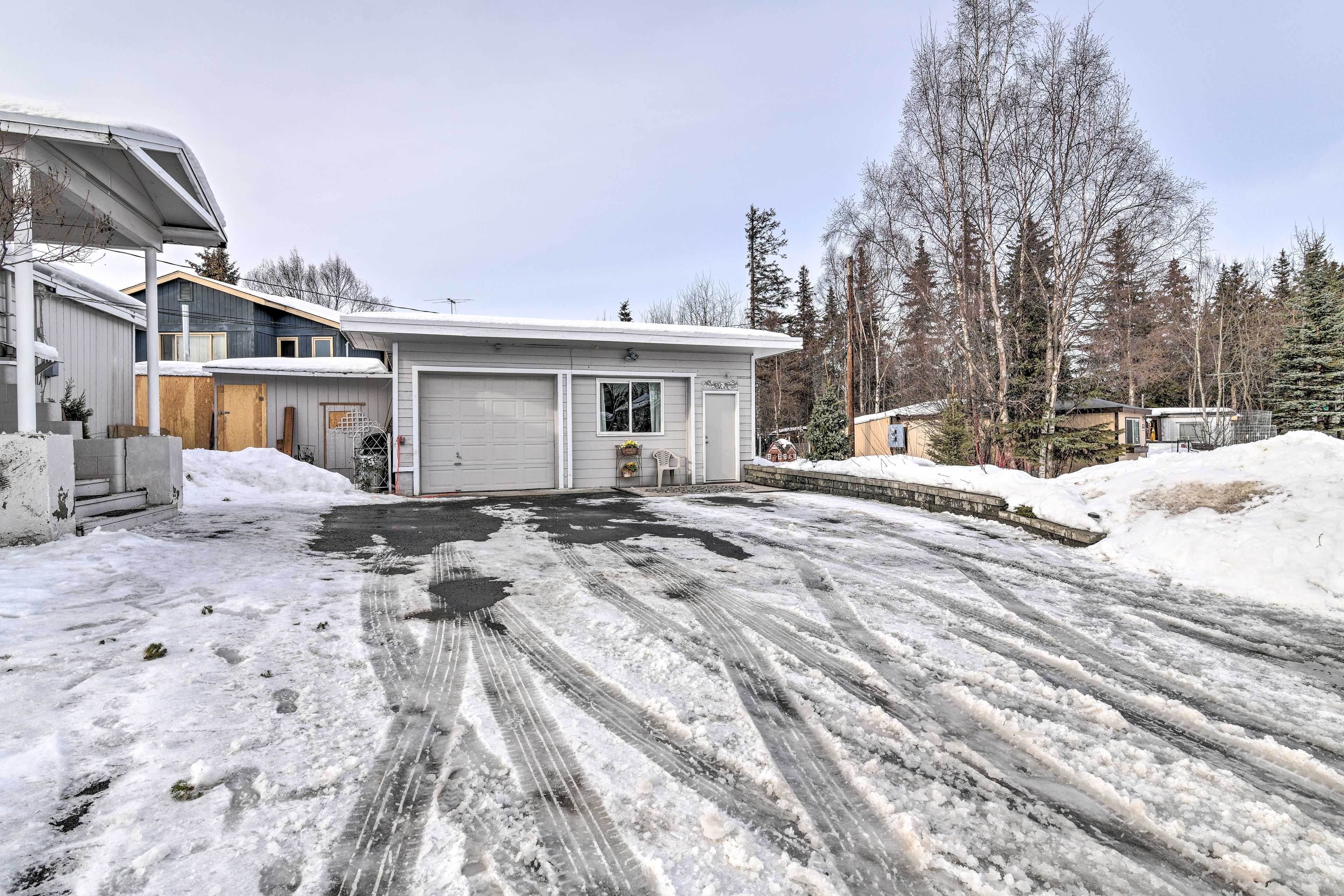 Two vehicles can park in the driveway.