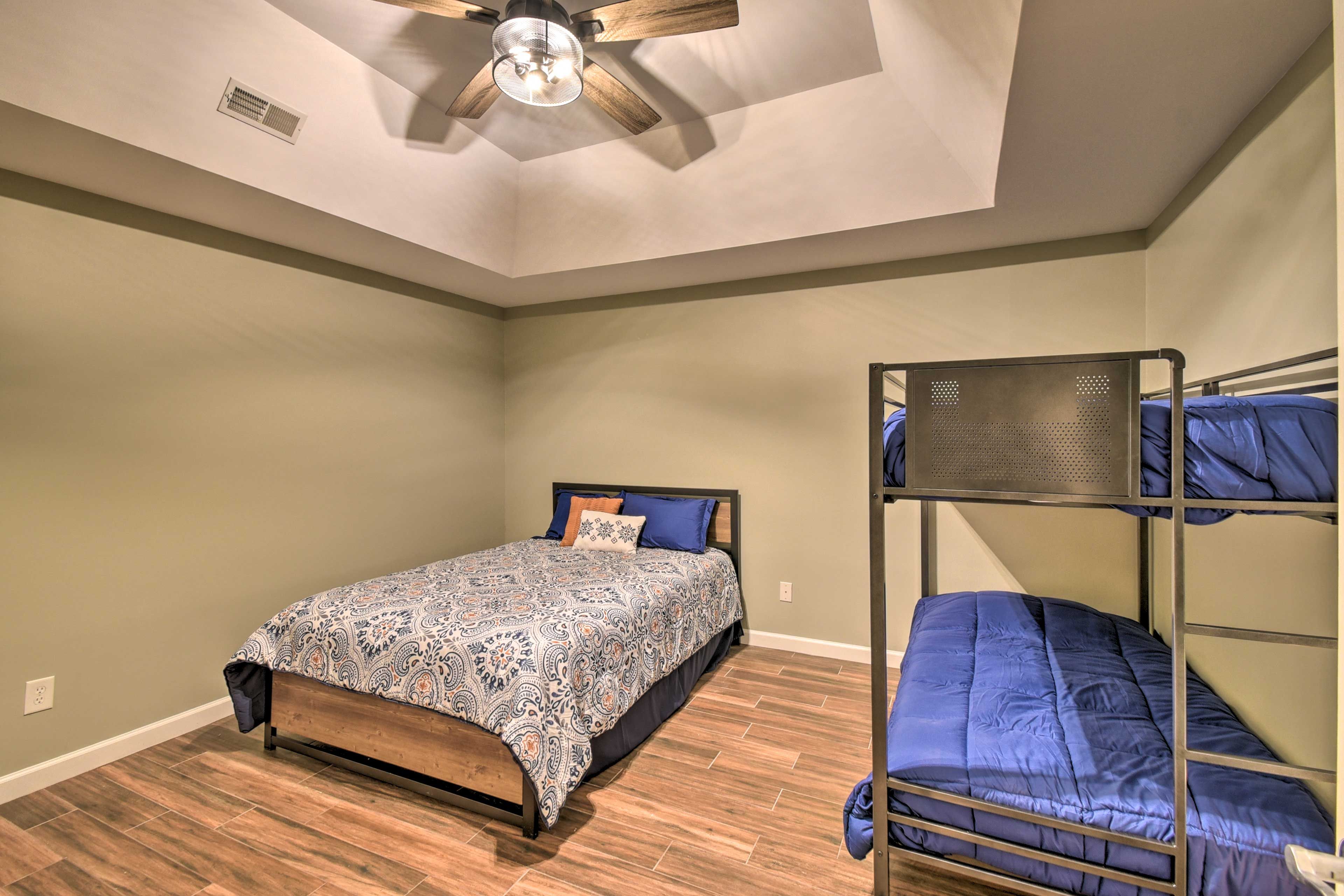 The second bedroom hosts a queen bed and a twin bunk bed.