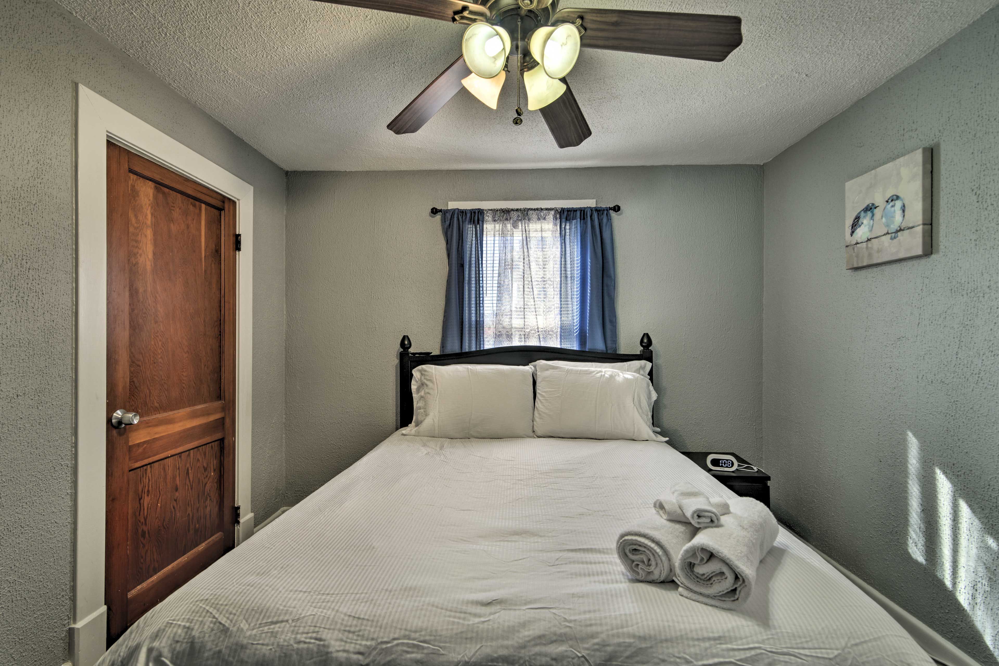 A queen bed resides in the first bedroom.