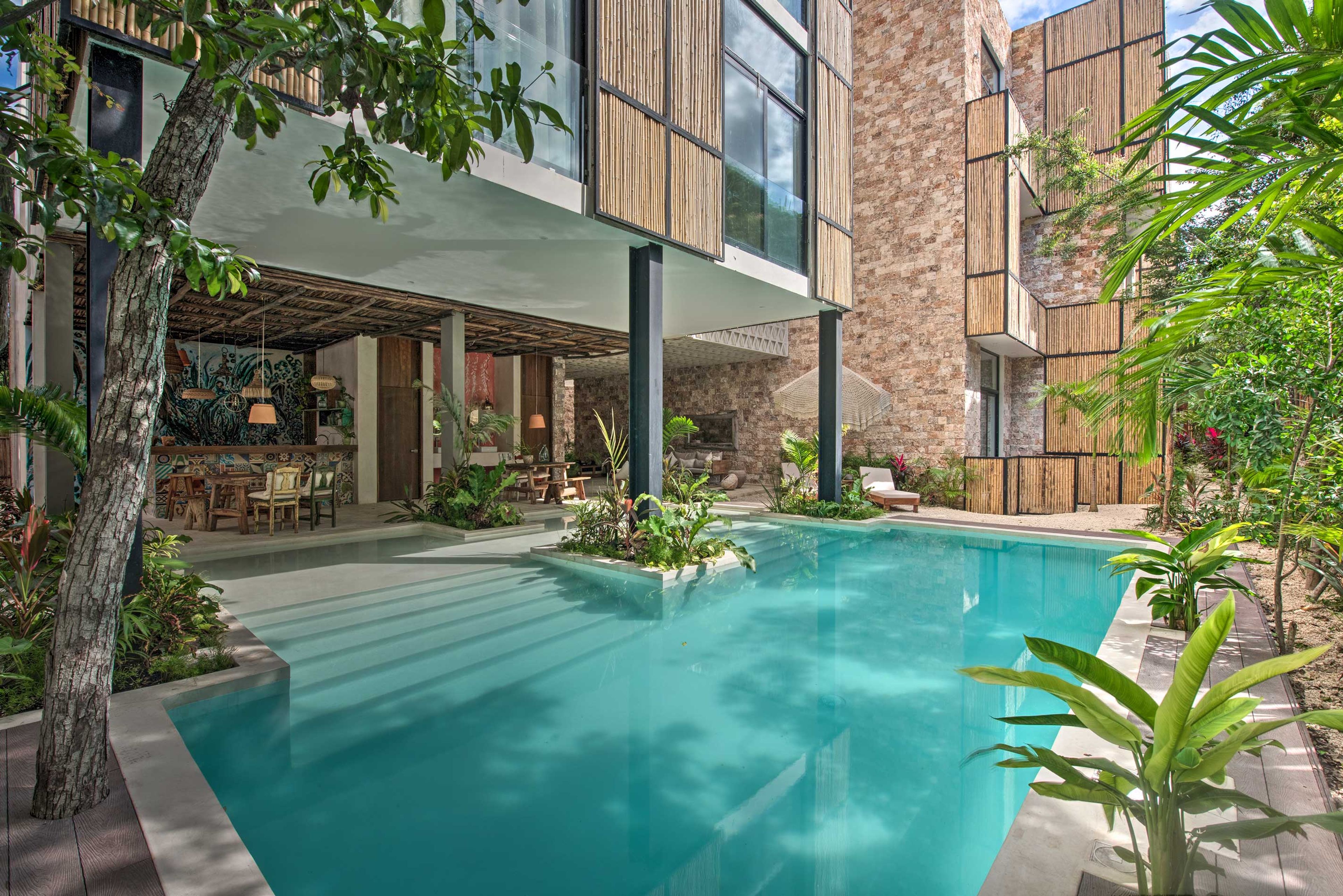 Lounge by the pool at this incredible condo in Tulum!