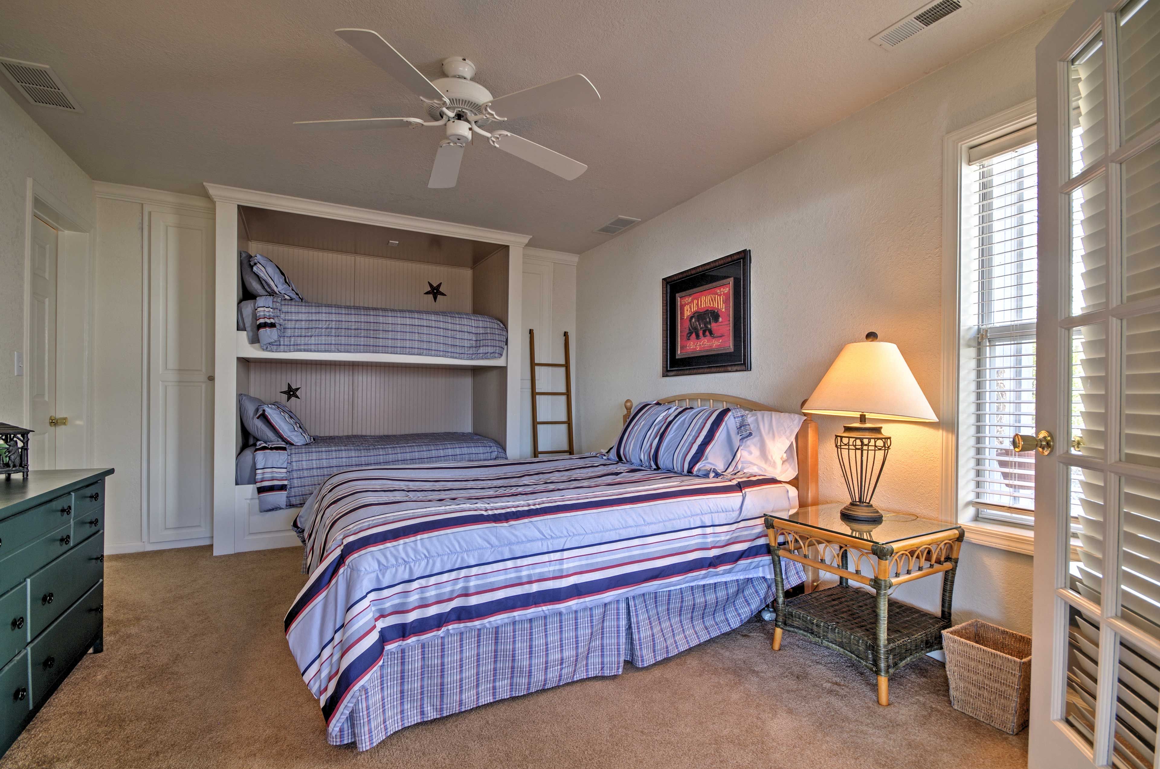 The second bedroom has a queen bed and a twin-over-twin bunk bed.