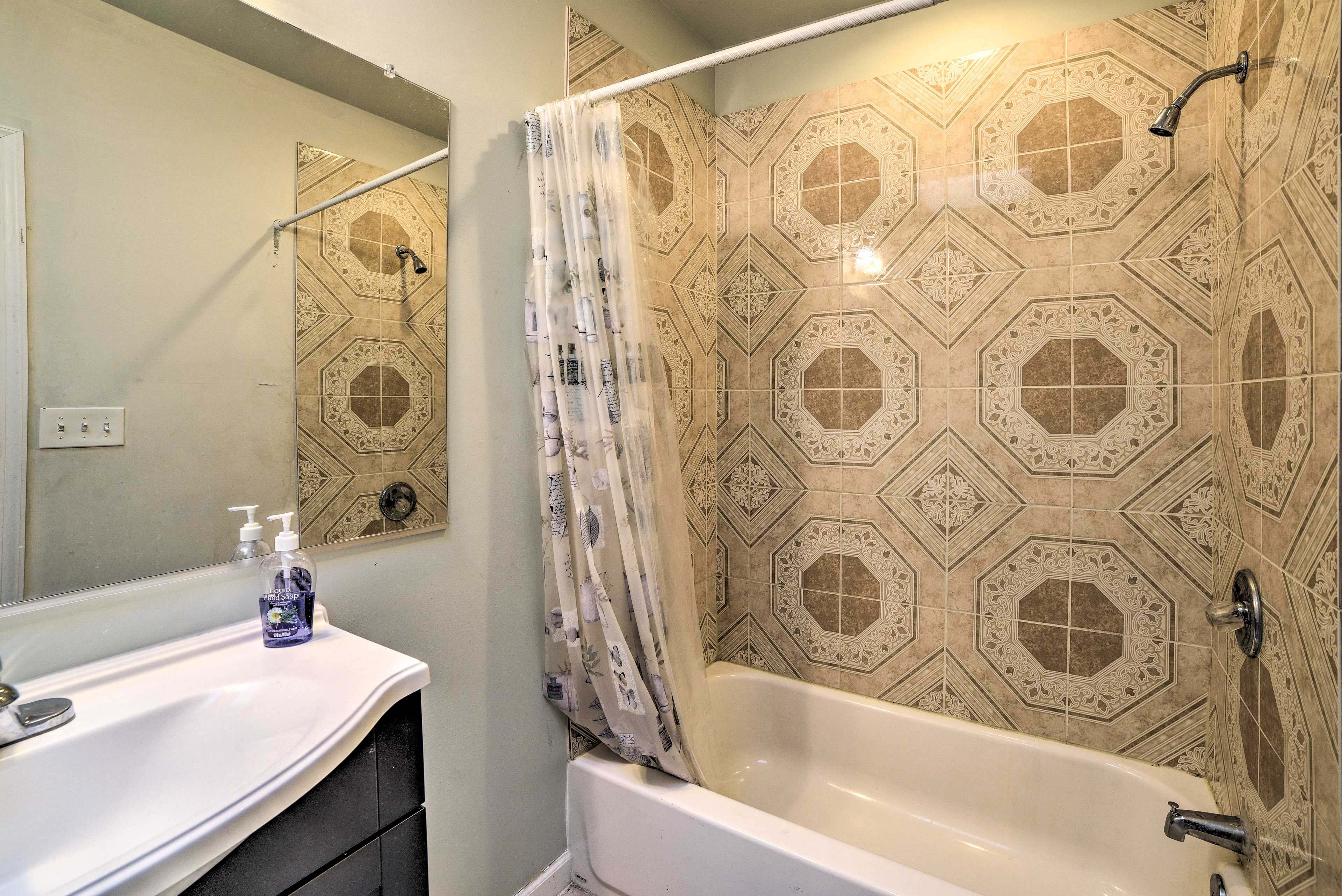 The room's en-suite bathroom has a shower/tub combo.