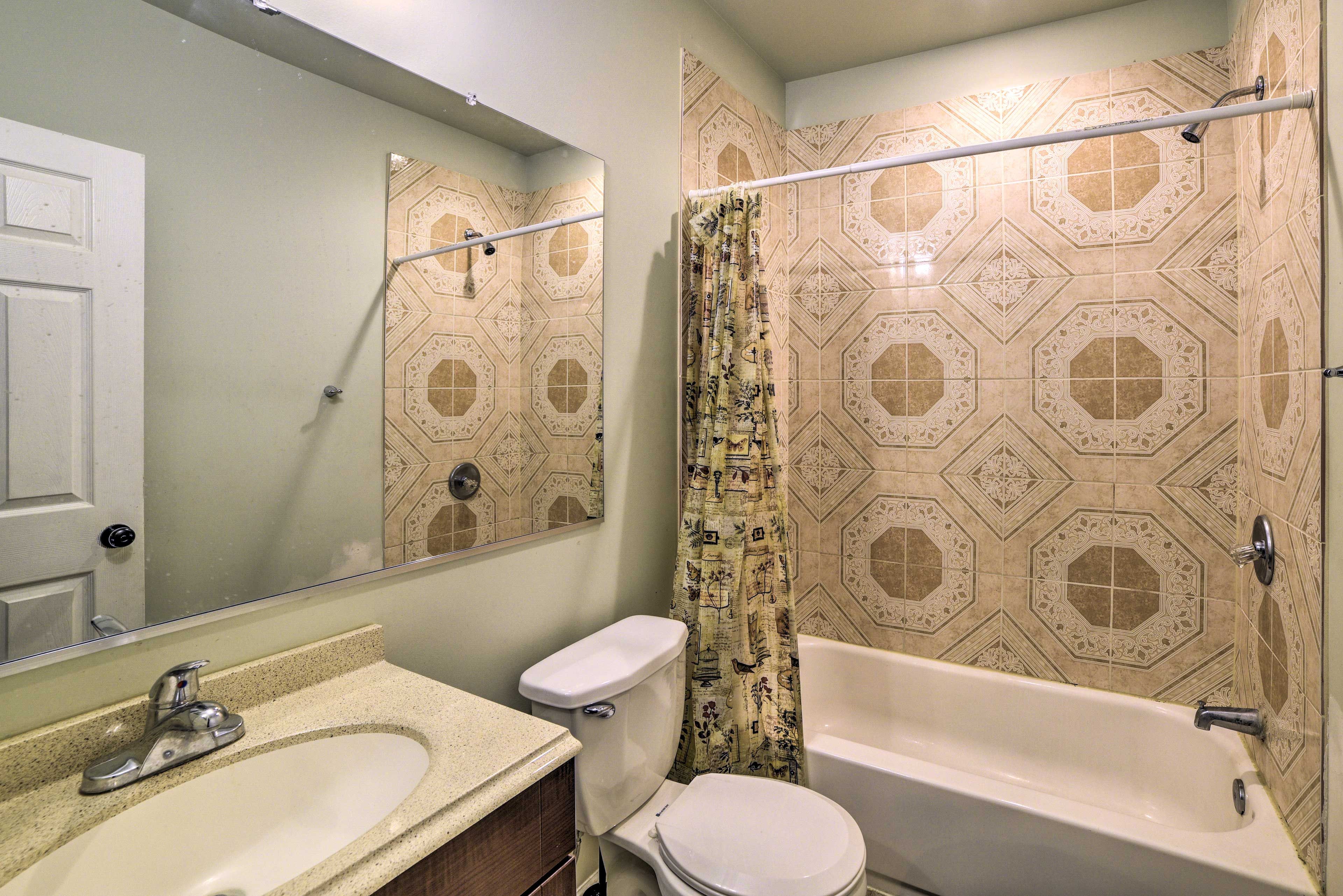 Wash away the day in the shower/tub combo.