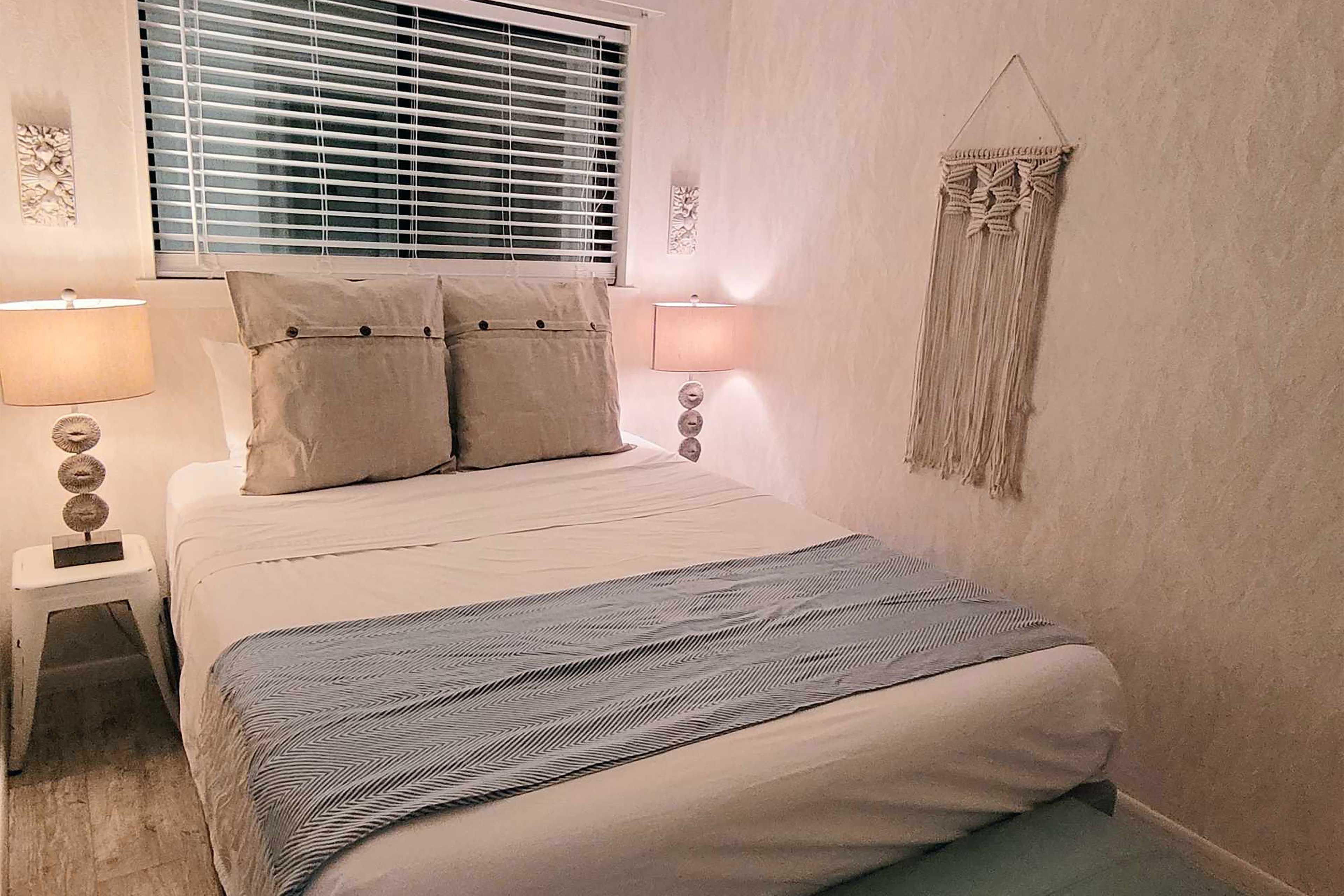 The bedroom boasts a queen bed.