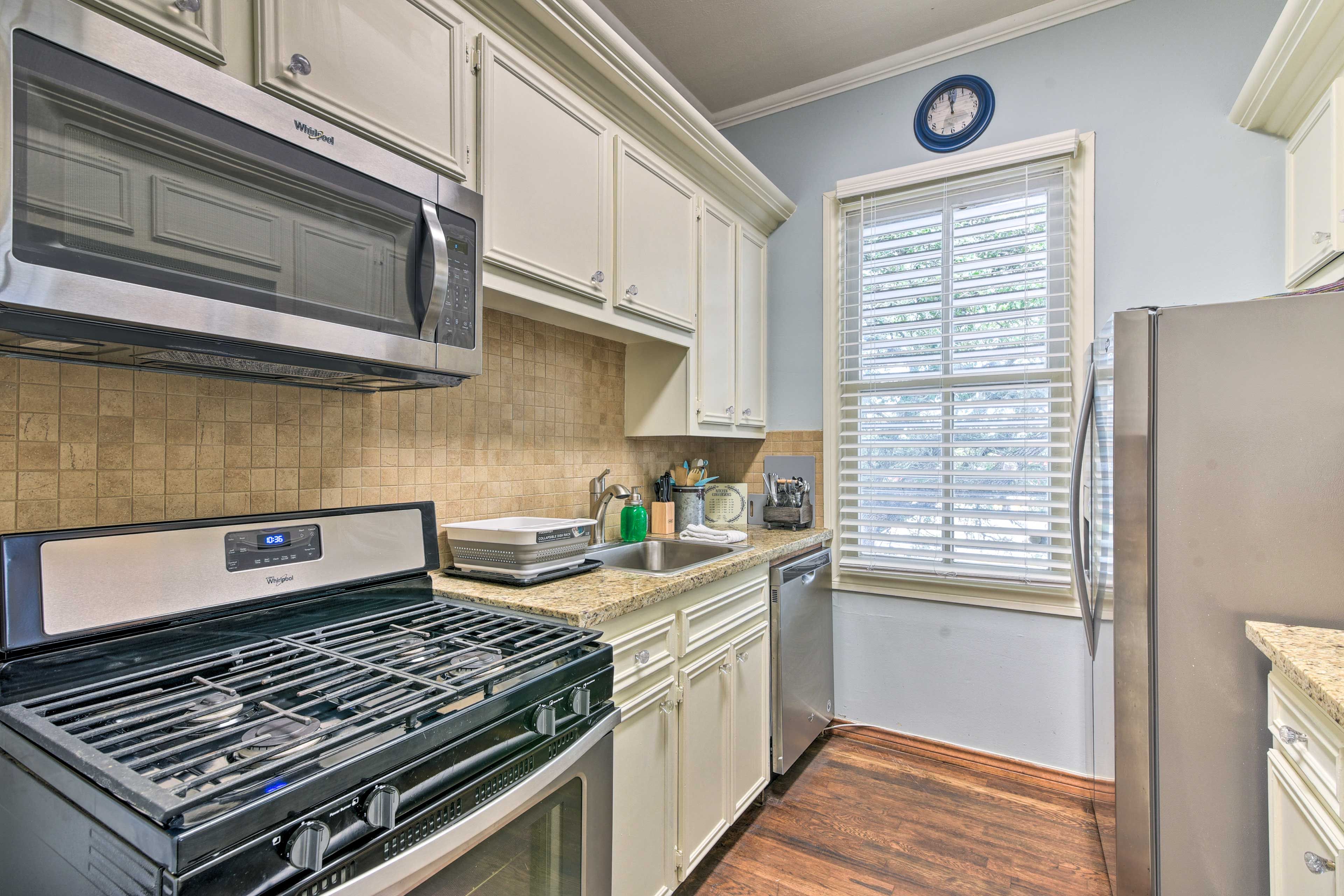 The galley-style kitchen is fully equipped with stainless steel appliances.