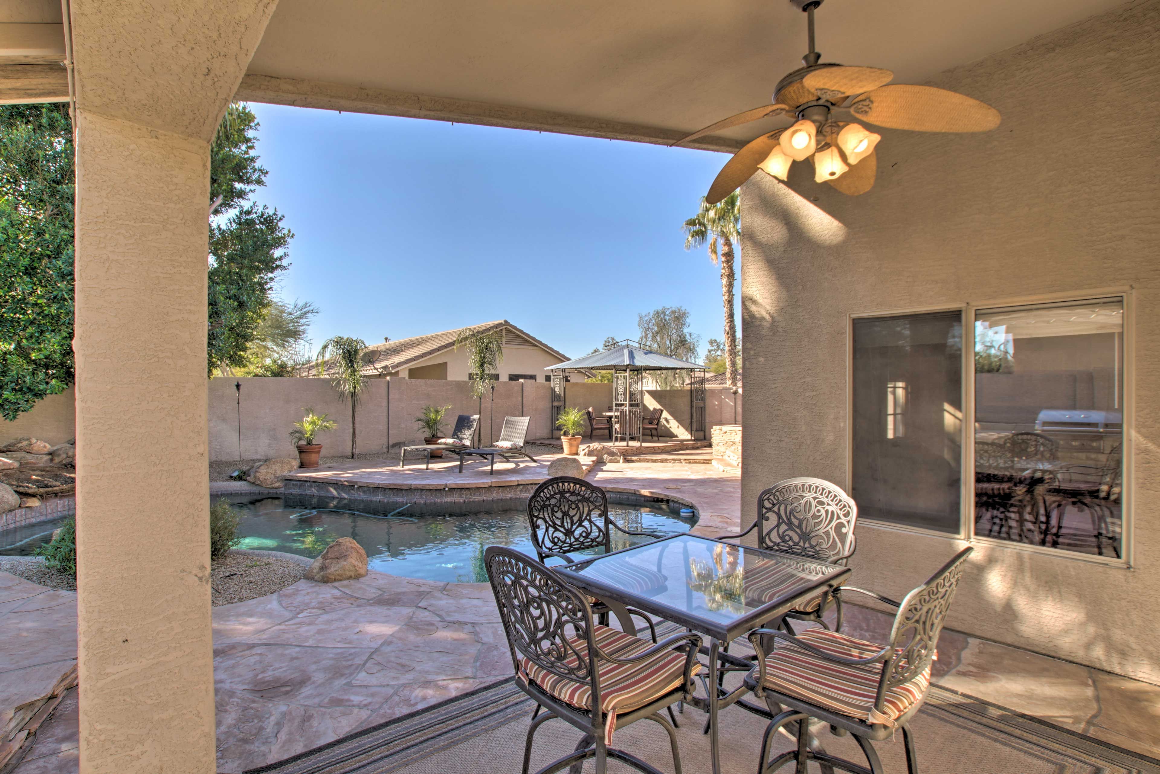 A dining table is shaded on the covered patio.