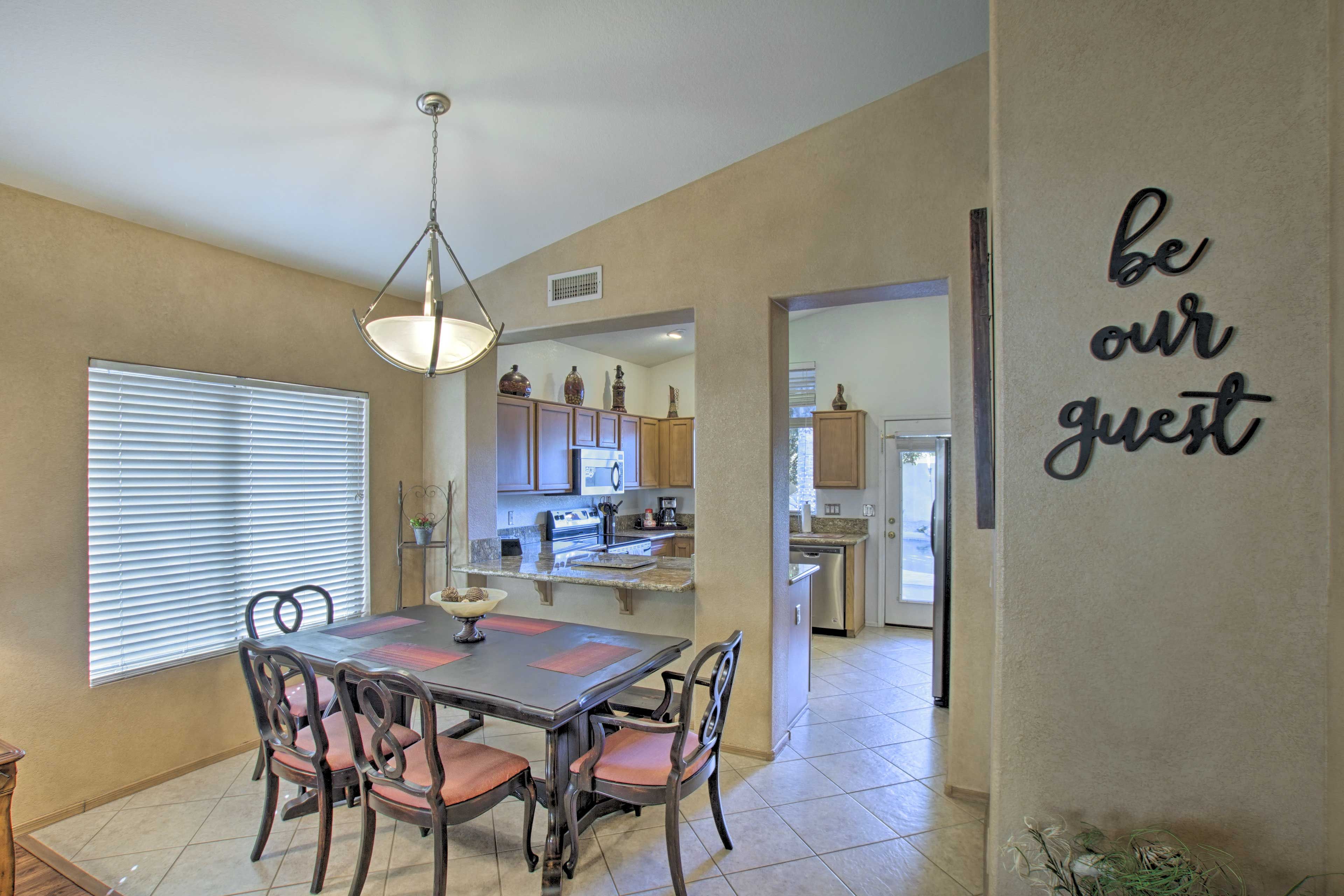 There is a 6-person dining table next to the kitchen.