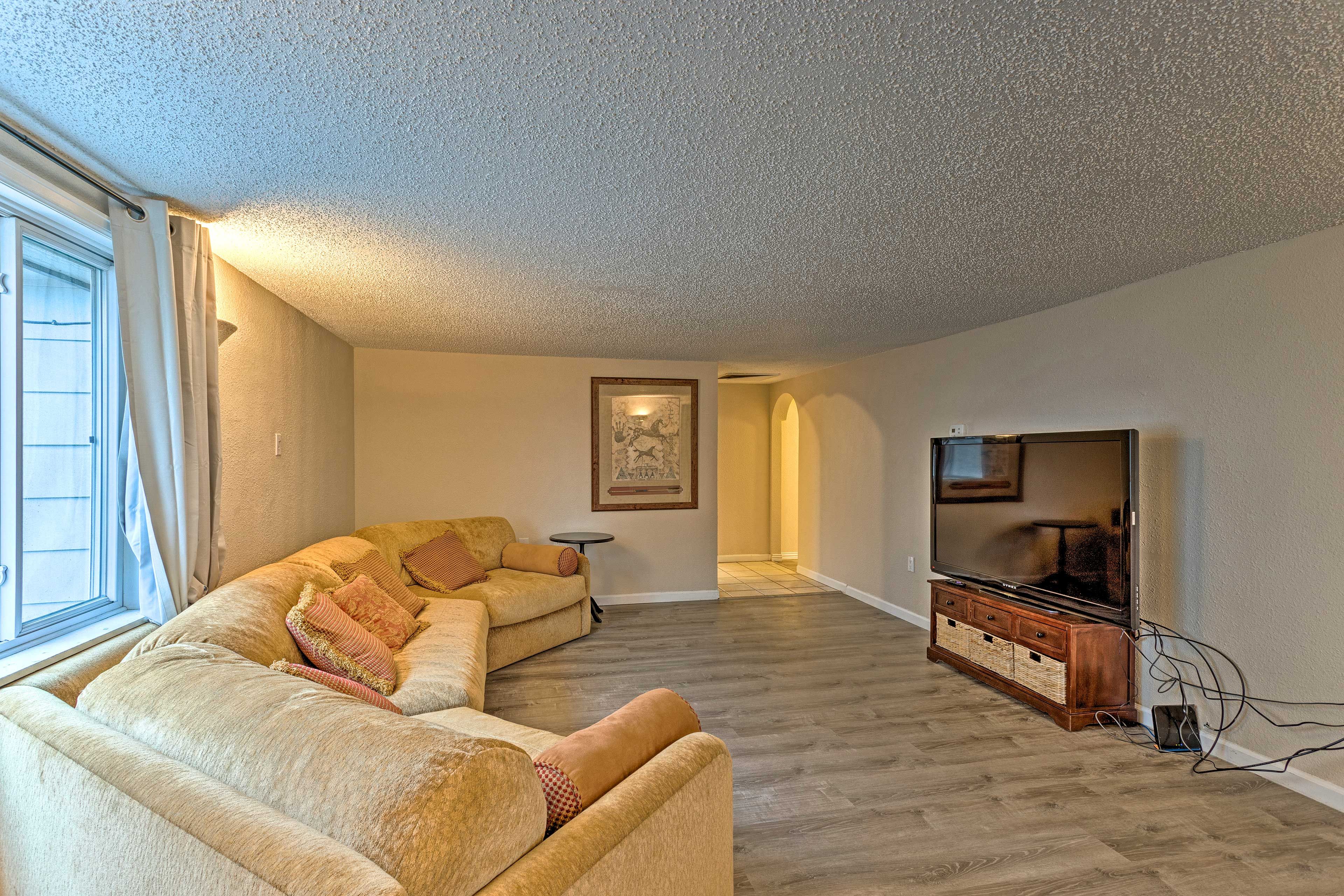 The living room includes a large sectional sofa.