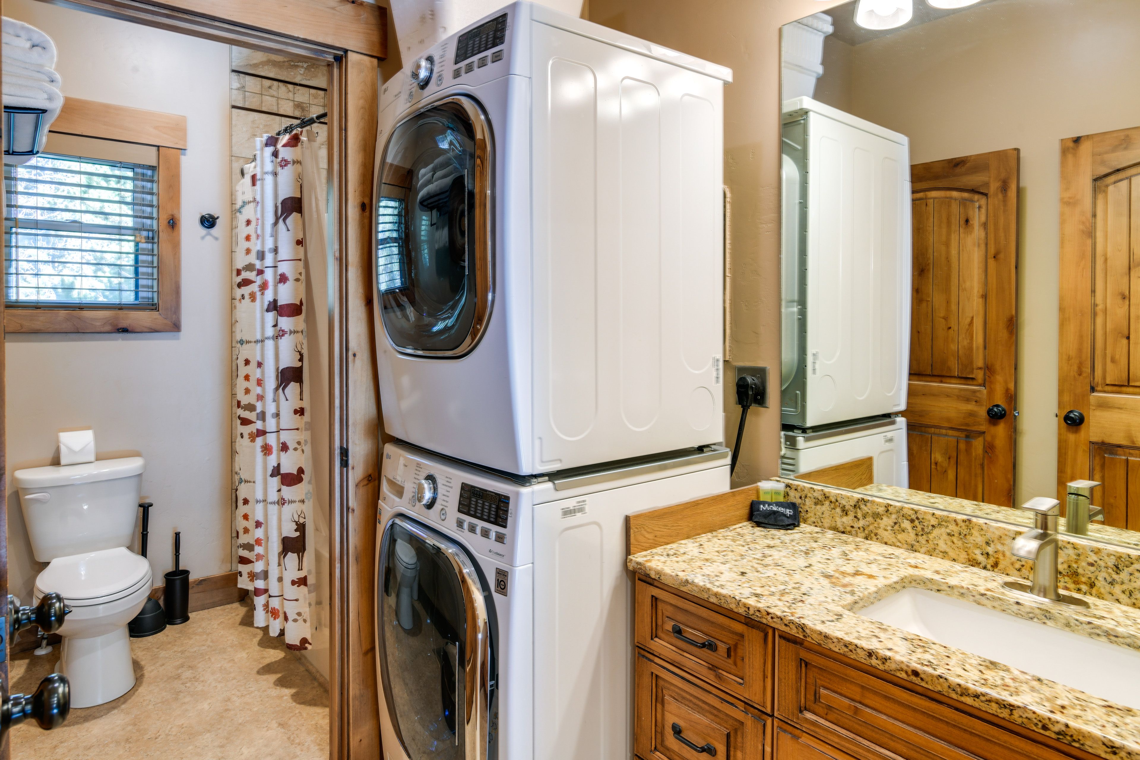 Full Bathroom | Stacked Laundry Machines