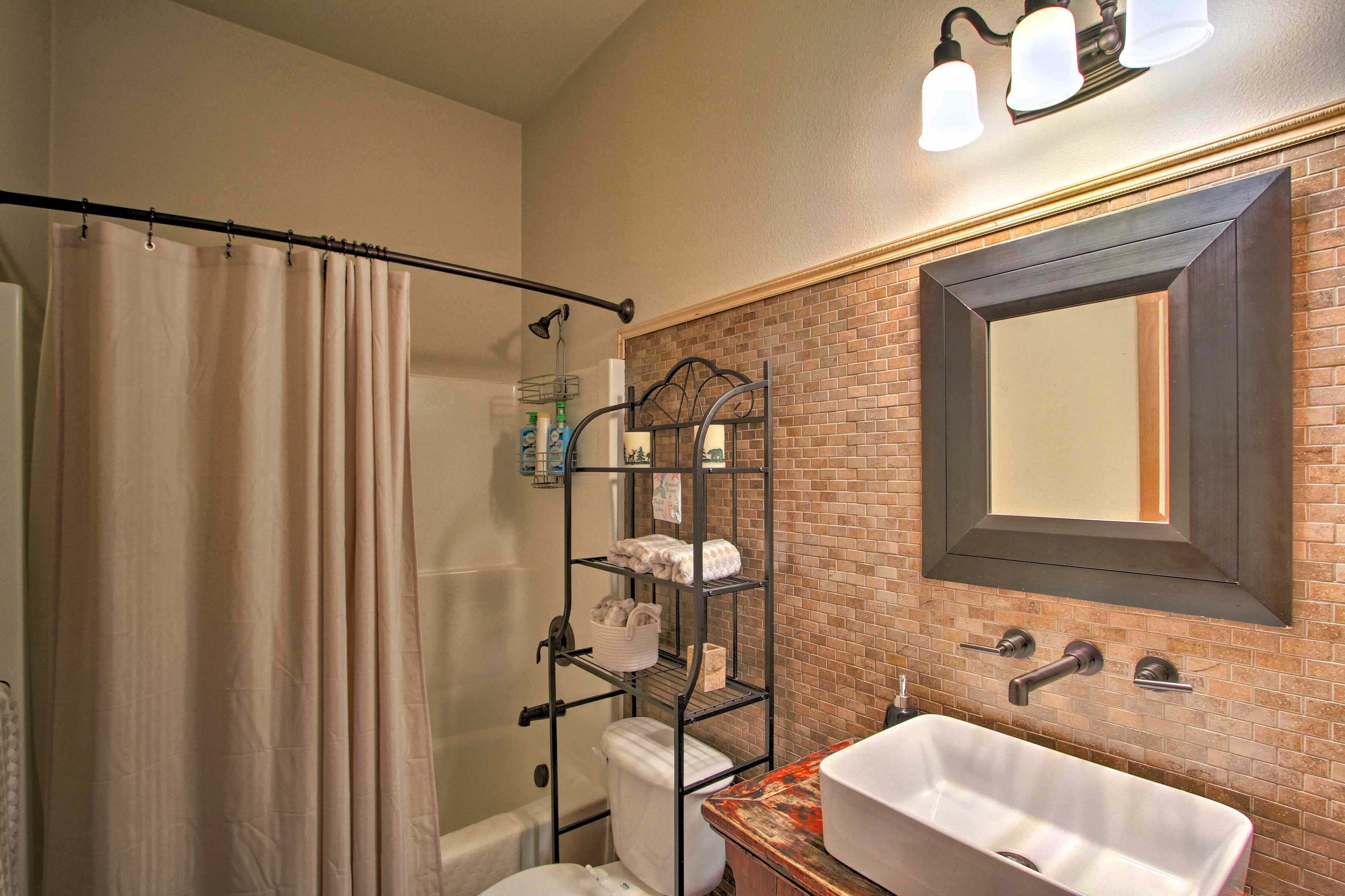 The second bathroom has a shower/tub combo for a spa night.