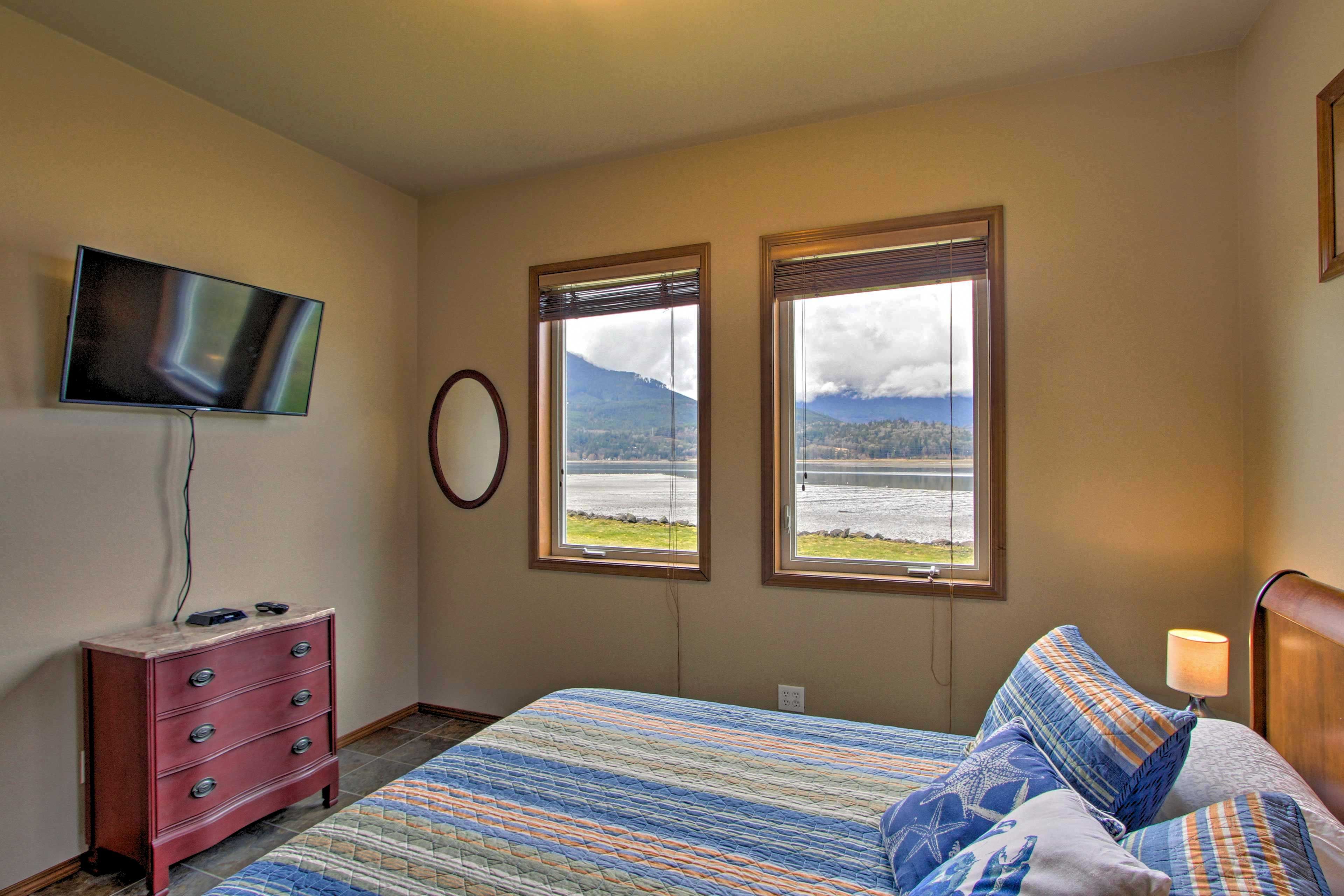 Lay in the queen bed and watch a late-night show on the Smart TV.