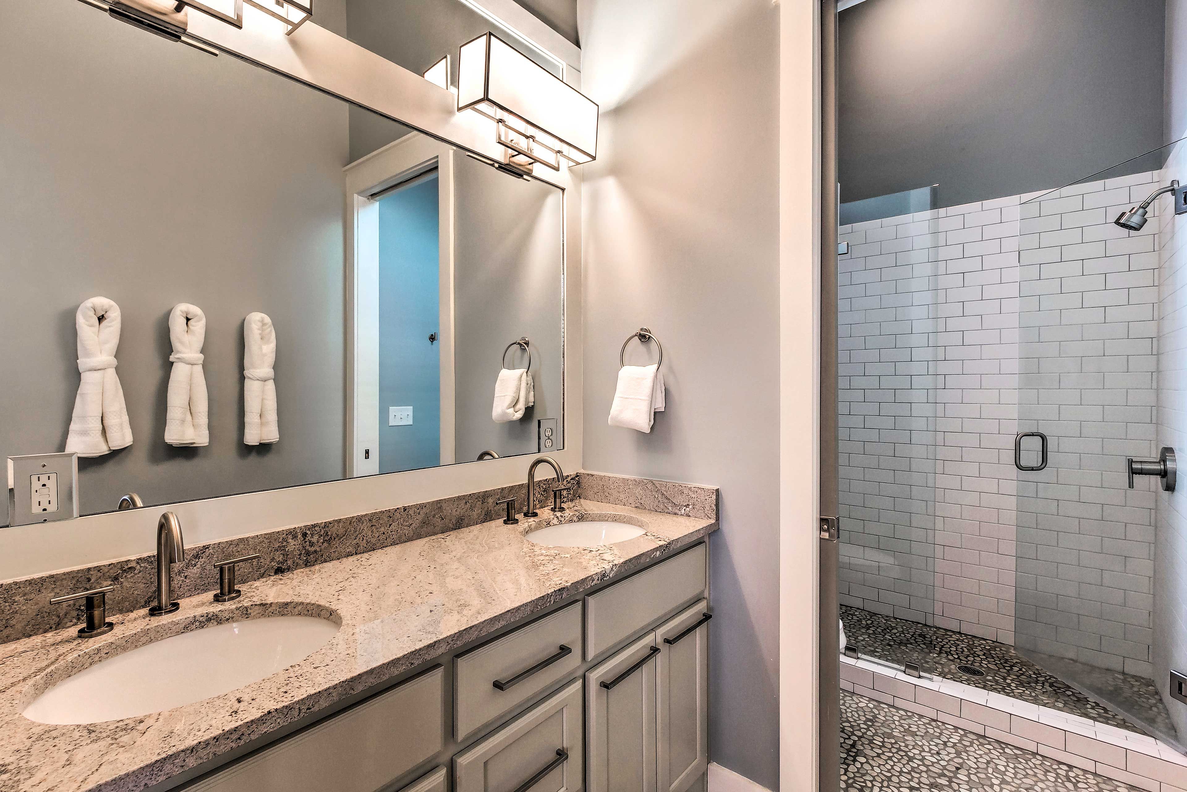 Barn doors reveal the en-suite bath.