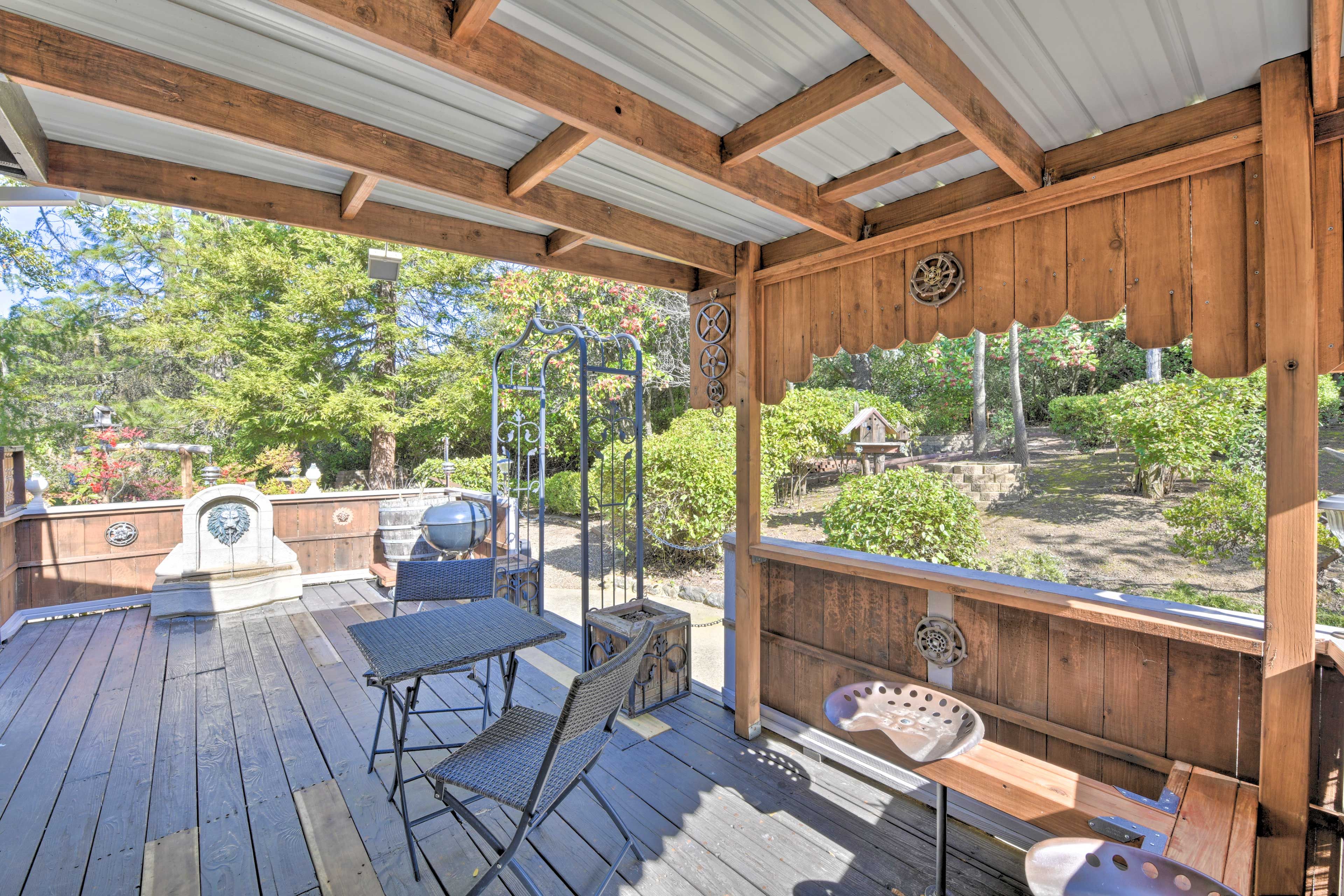 Covered Deck | Dining Area | Fountain | Landscaped Backyard