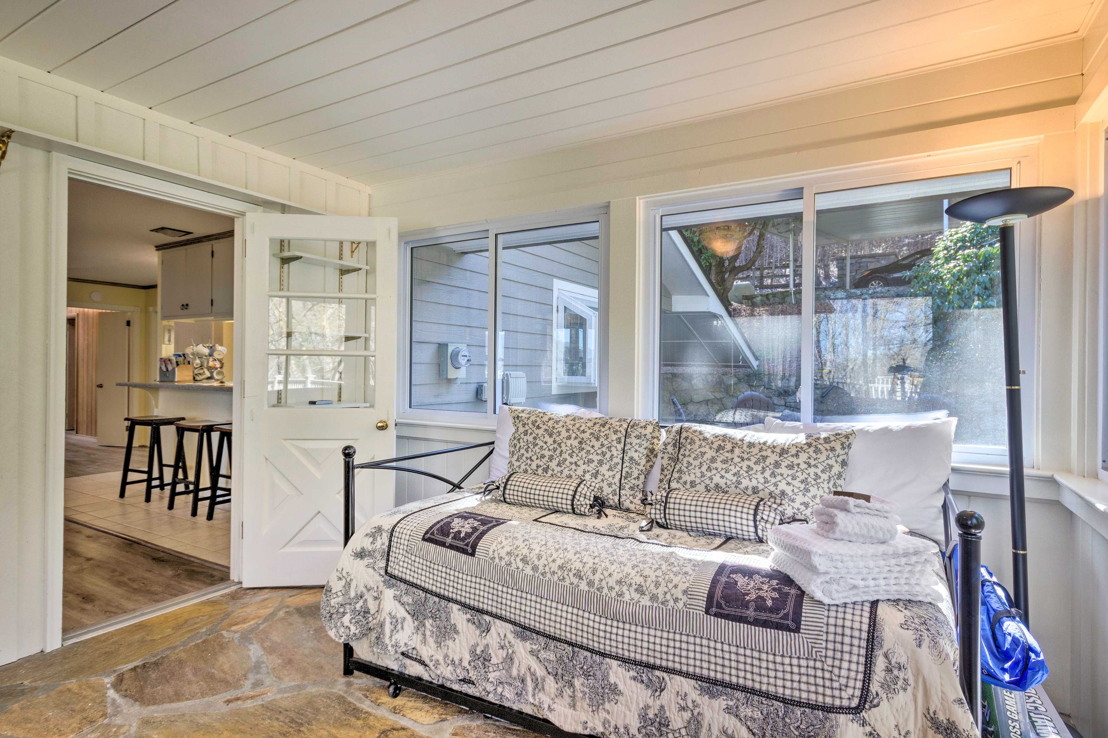 The sunroom has a full-sized daybed.