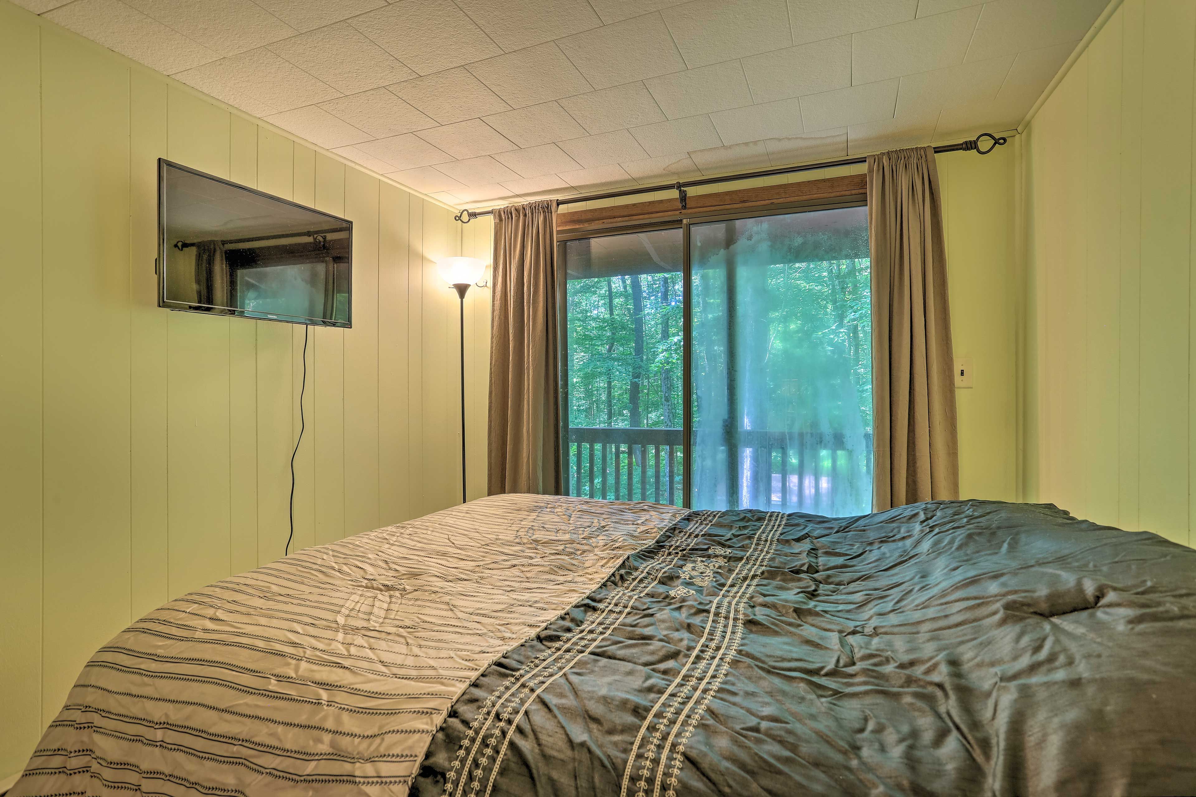 The master bedroom features a queen-sized bed and Smart TV.