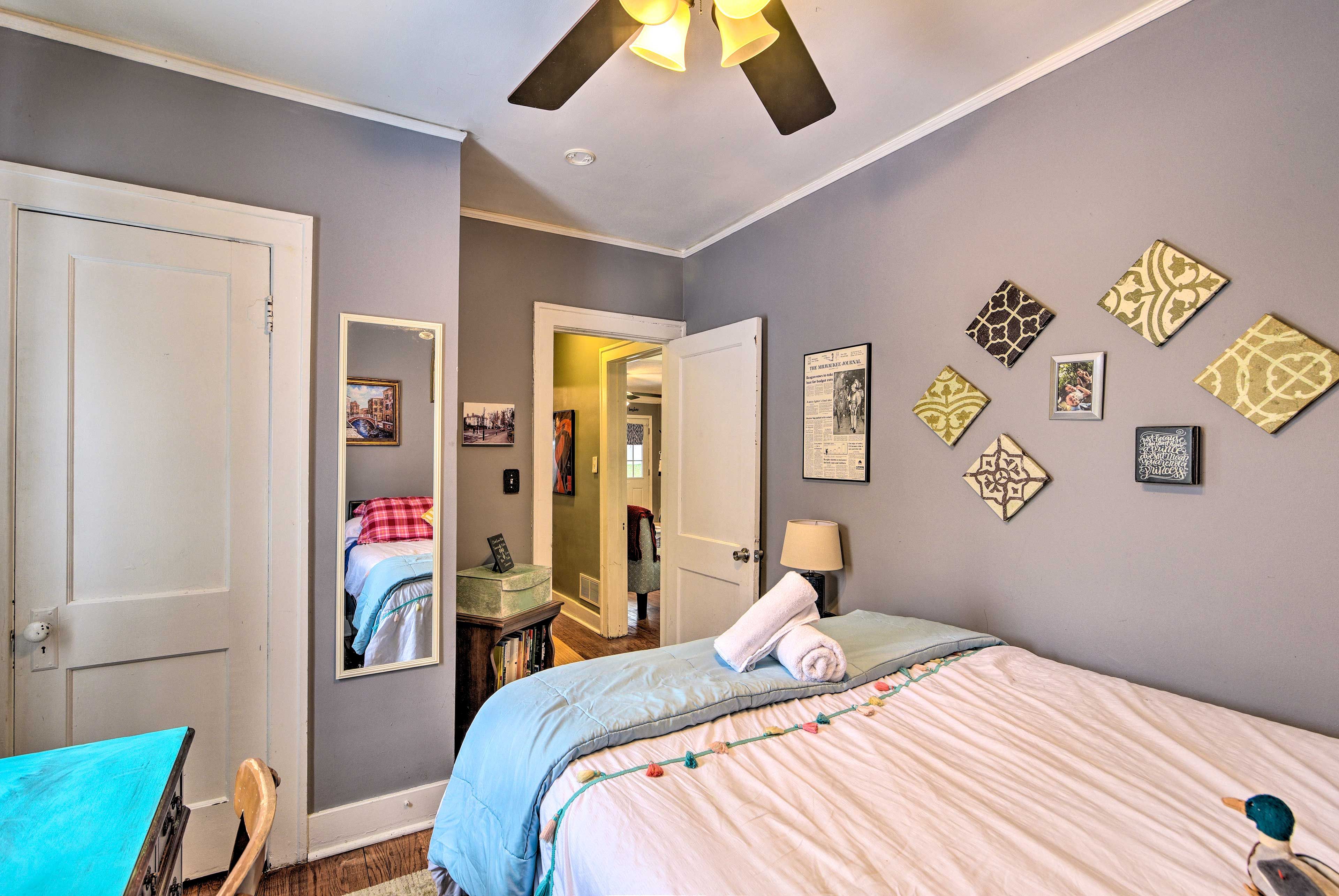 A laptop-friendly workspace completes this room.