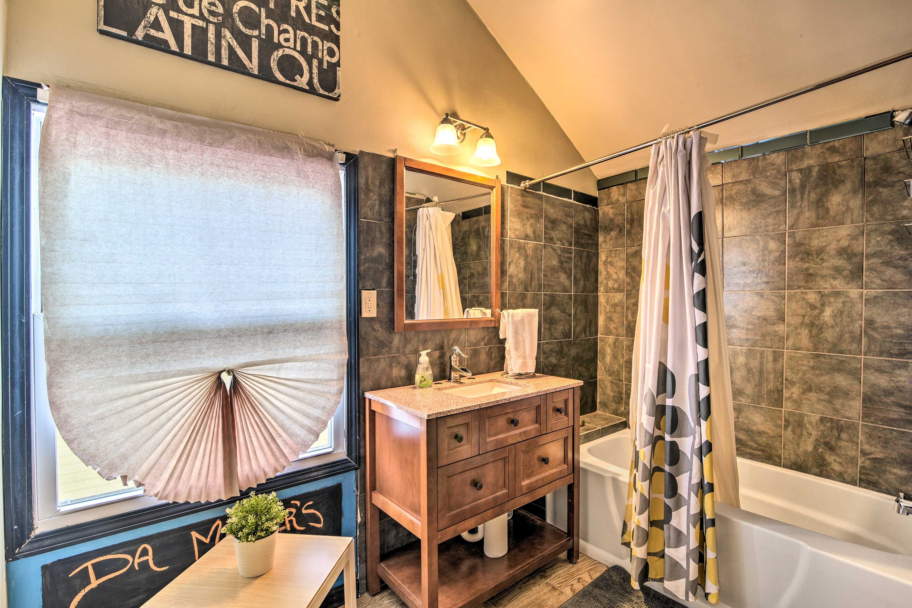 This bathroom is equipped with a shower/tub combo.